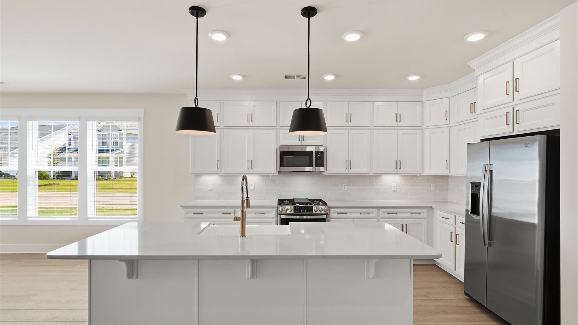 Exceptional kitchen featuring a spacious island, eye-catching pendant lights, and modern finishes in Inman, SC