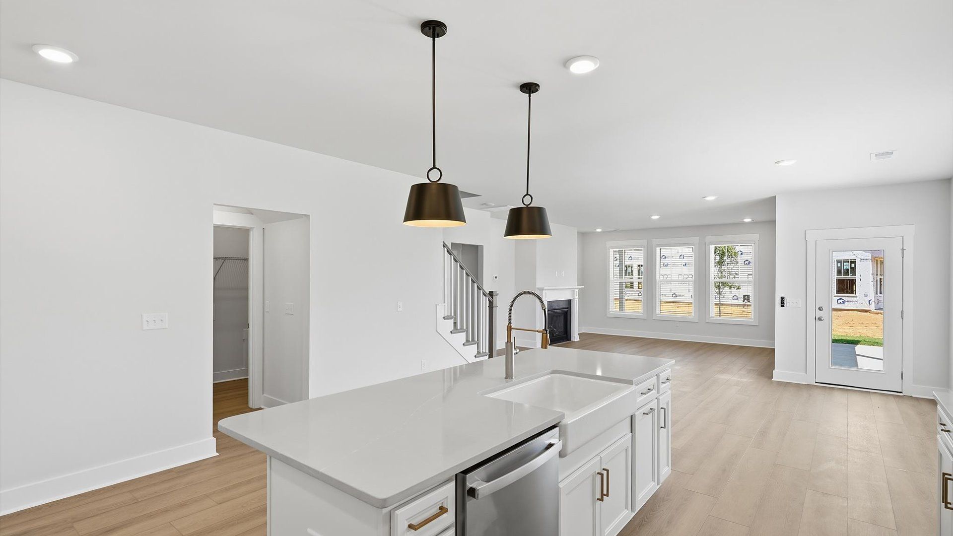 Tasteful kitchen with oversized island and stylish pendant lighting—crafted to high standards at Walnut Ridge