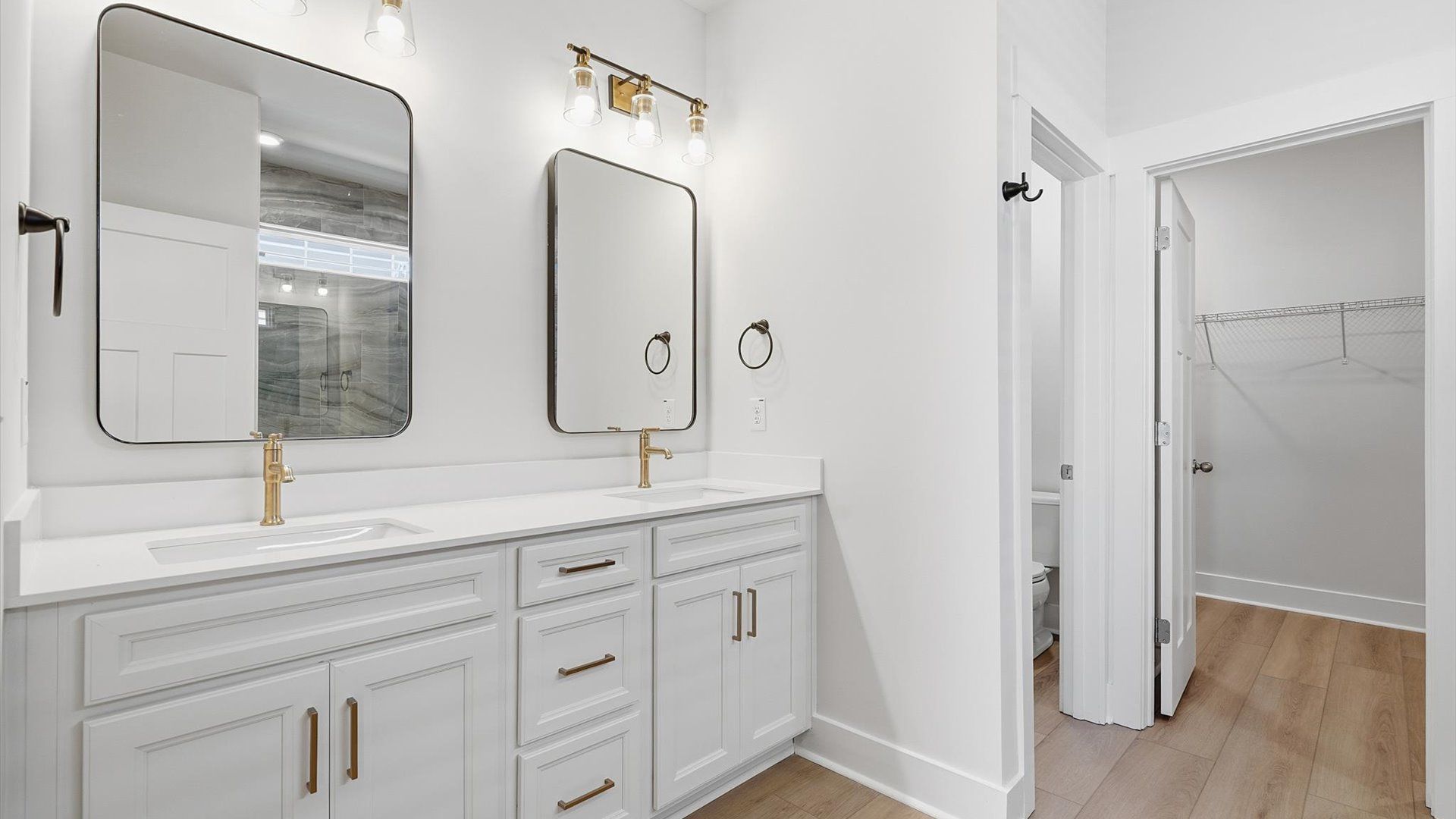 Tasteful primary bath with modern finishes, a walk-in shower, and thoughtful double vanity layout at Walnut Ridge