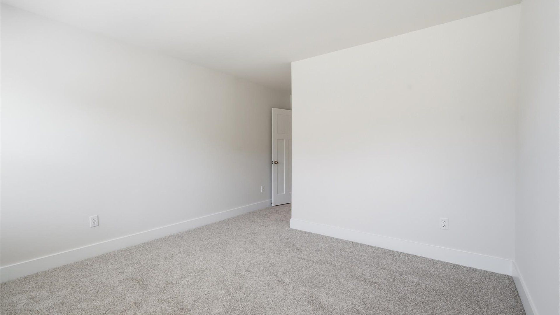 First-rate secondary bedroom with a spacious walk-in closet and elegant carpeted flooring at the Walnut Ridge community