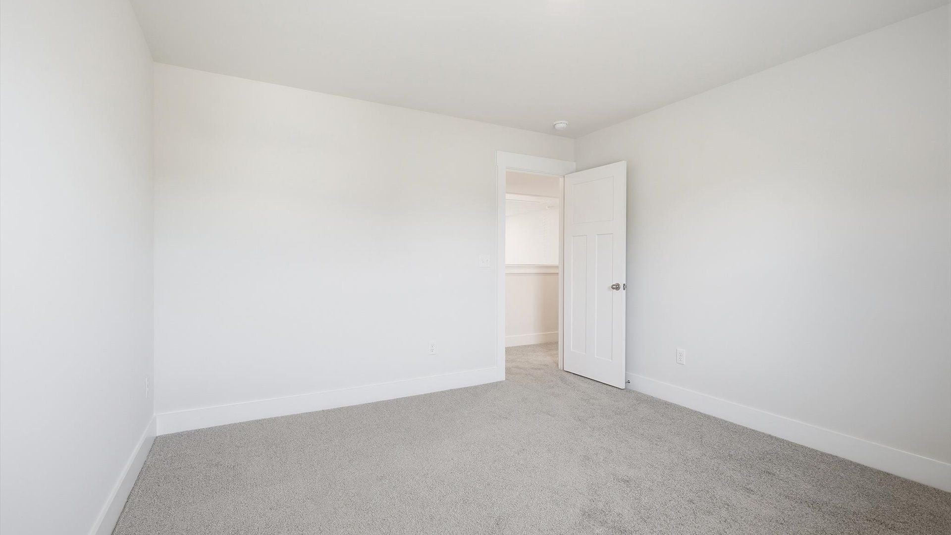 Bright and serene bedroom with comfortable carpeted flooring located near Lake Bowen