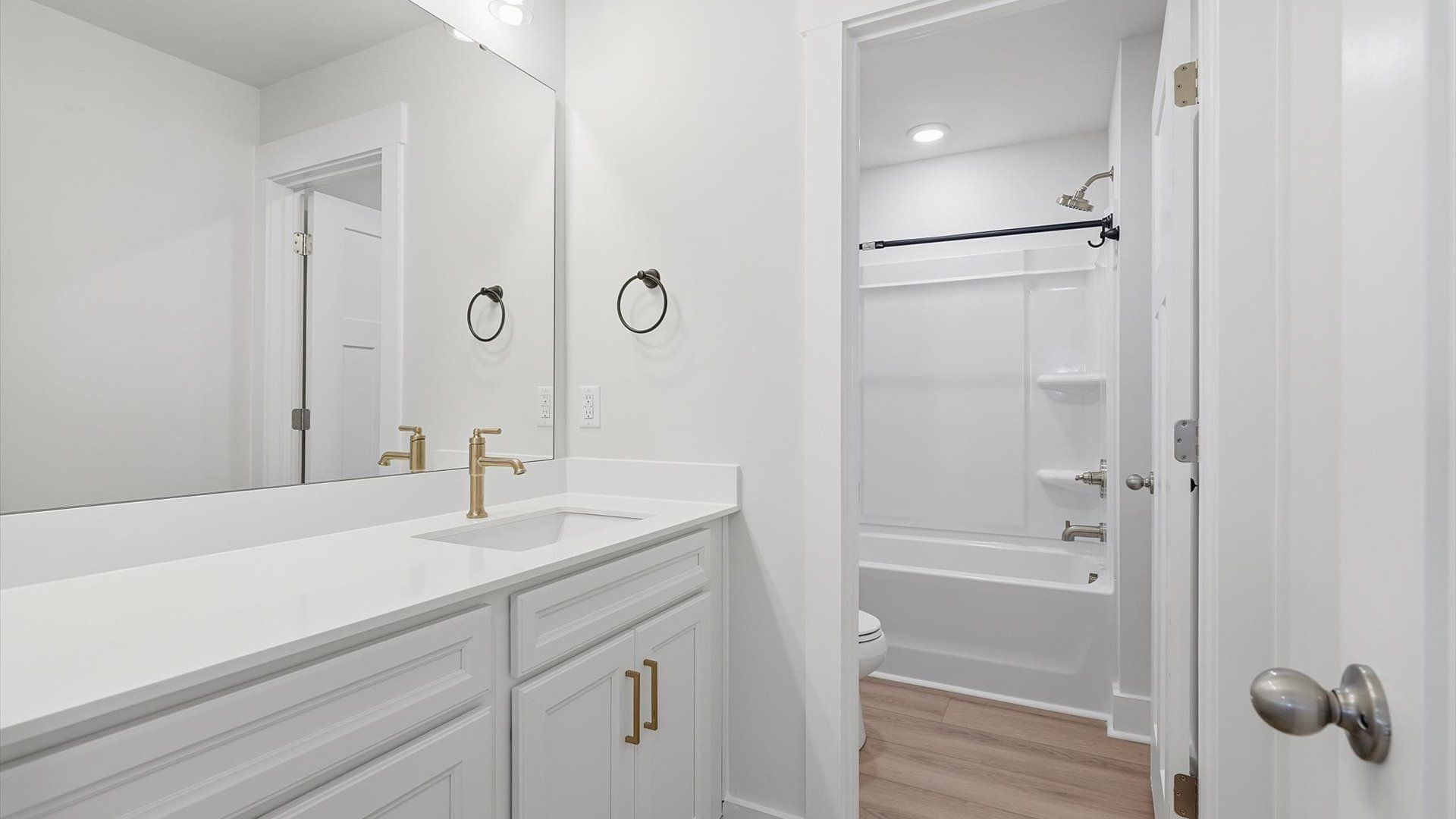 Top-notch bathroom with current fixtures, tasteful materials, and elevated charm by DRB Homes
