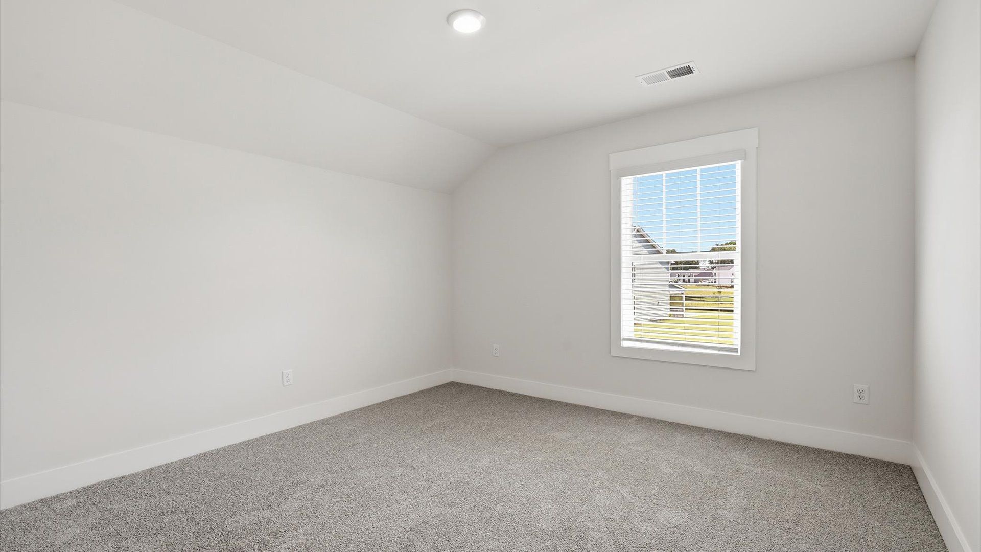 Highly functional bedroom with a large window, carpeted flooring, and tasteful finishes throughout at Walnut Ridge