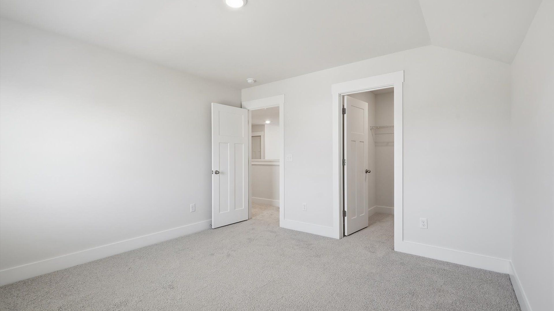 Notable secondary bedroom offering cozy carpeted flooring and a stylish walk-in closet in Inman, SC