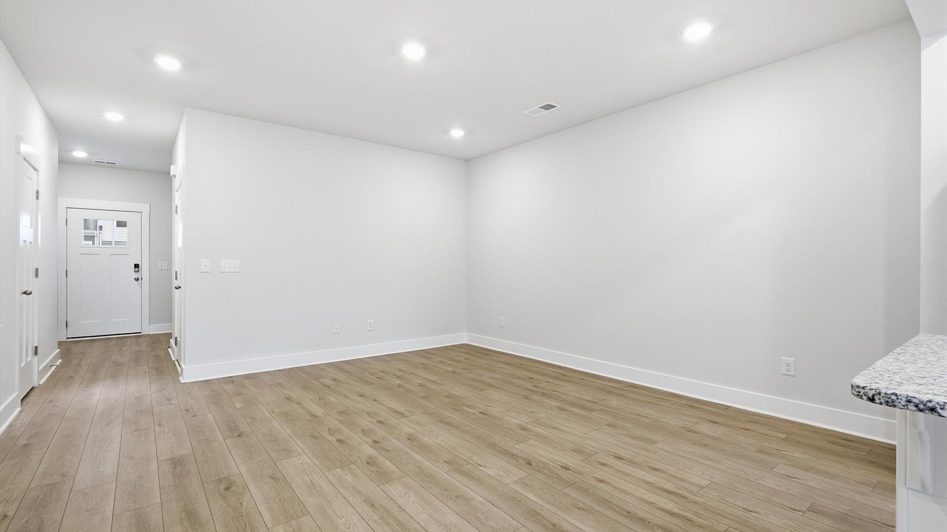 Highly skilled craftsmanship and modern elegance meet in this family room with high ceilings near Downtown Greer