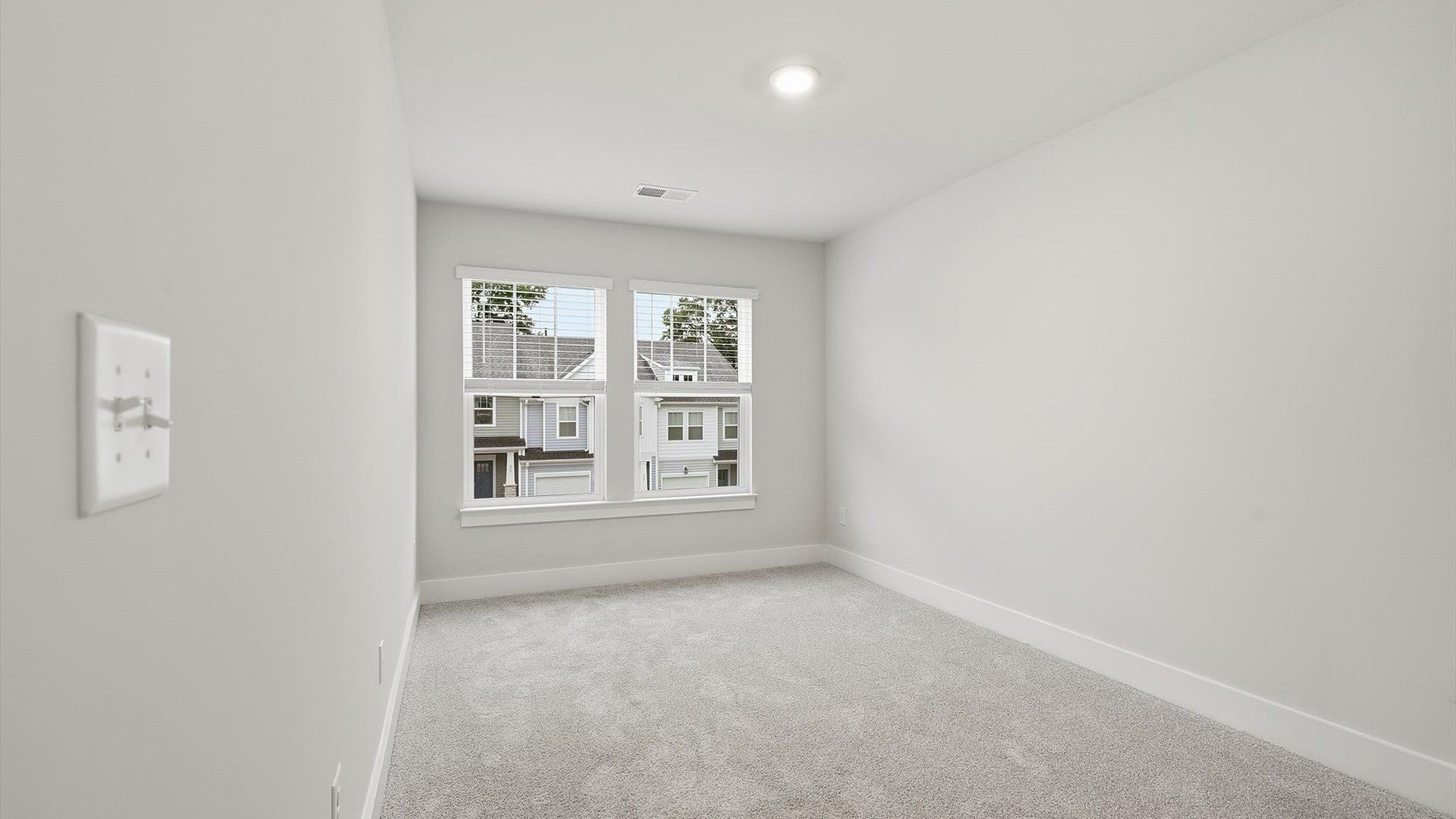 Inviting bedroom with tasteful finishes and large windows that create a fresh, open ambiance by DRB Homes