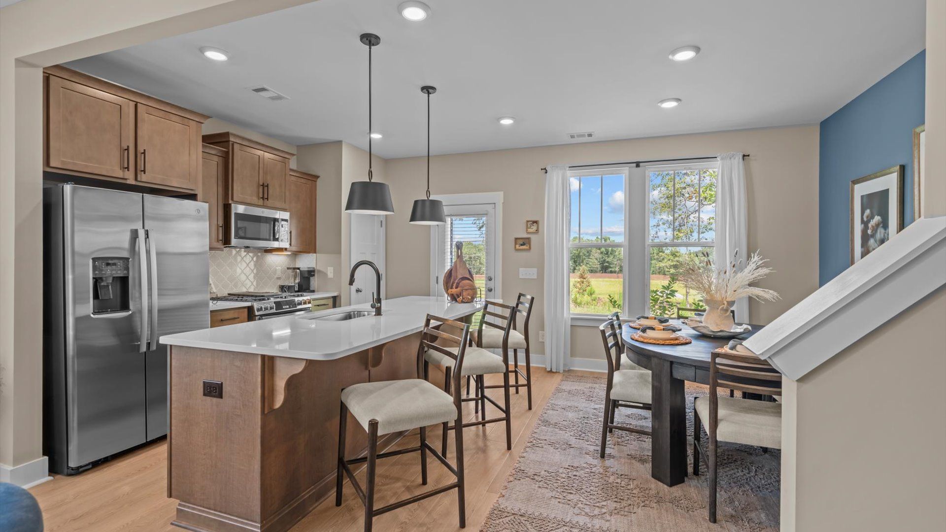 Tasteful kitchen with streamlined island and modern finishes in a DRB Home at Brookland Place in Henderson County