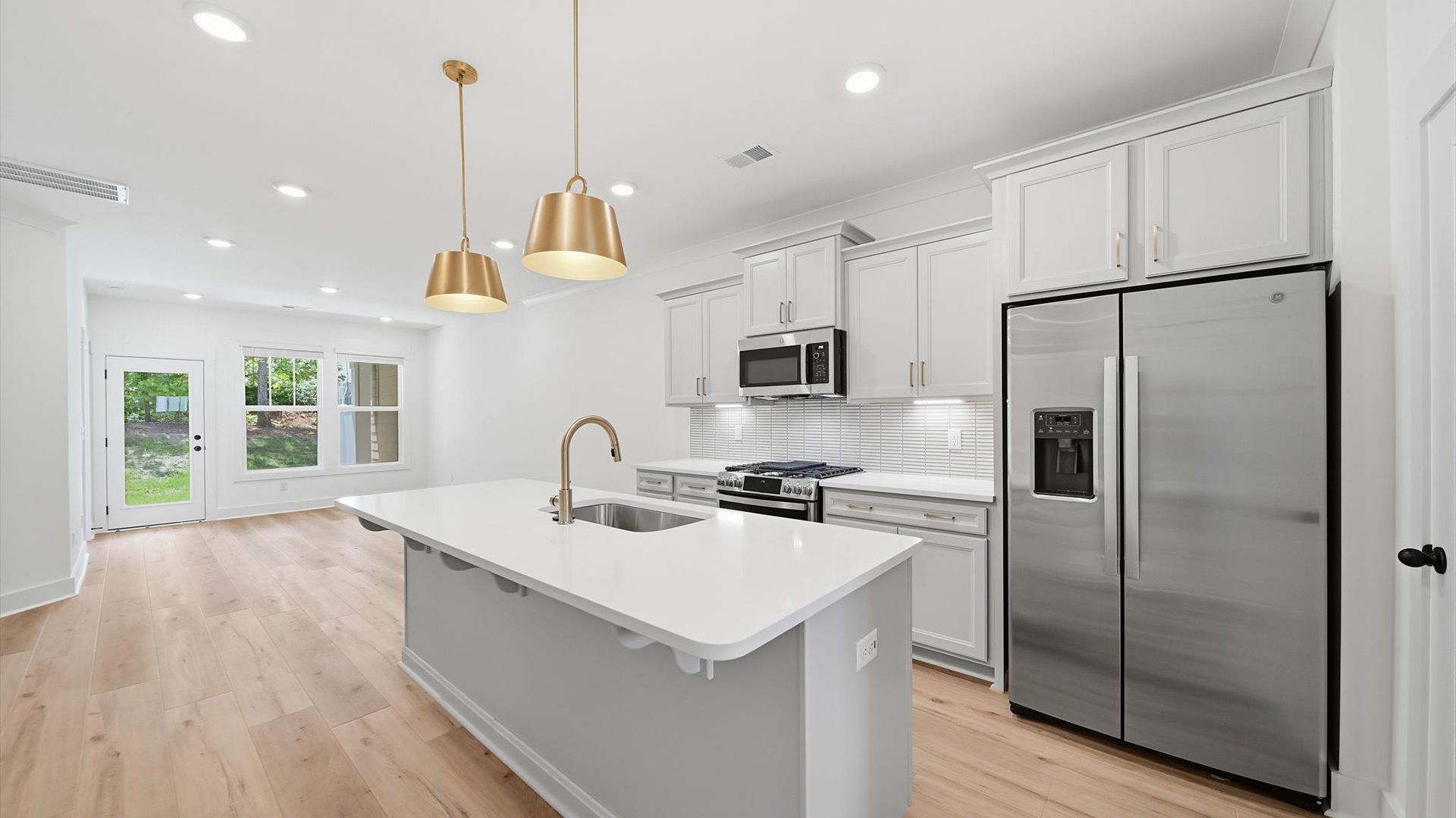 Notable kitchen space with elegant pendant lighting and a large island perfect for entertaining