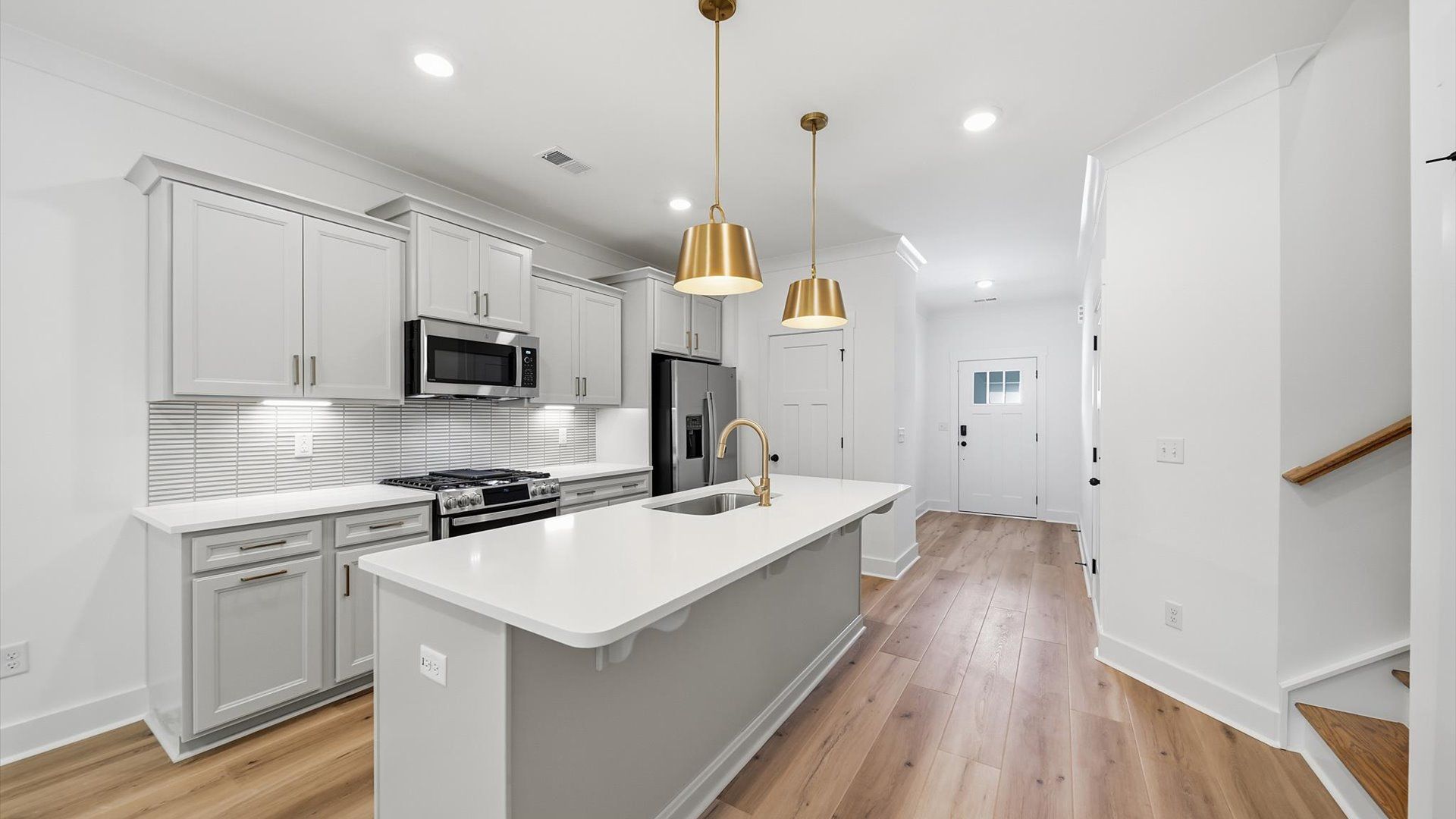 Exceptional kitchen featuring a spacious island, eye-catching pendant lights, and modern finishes