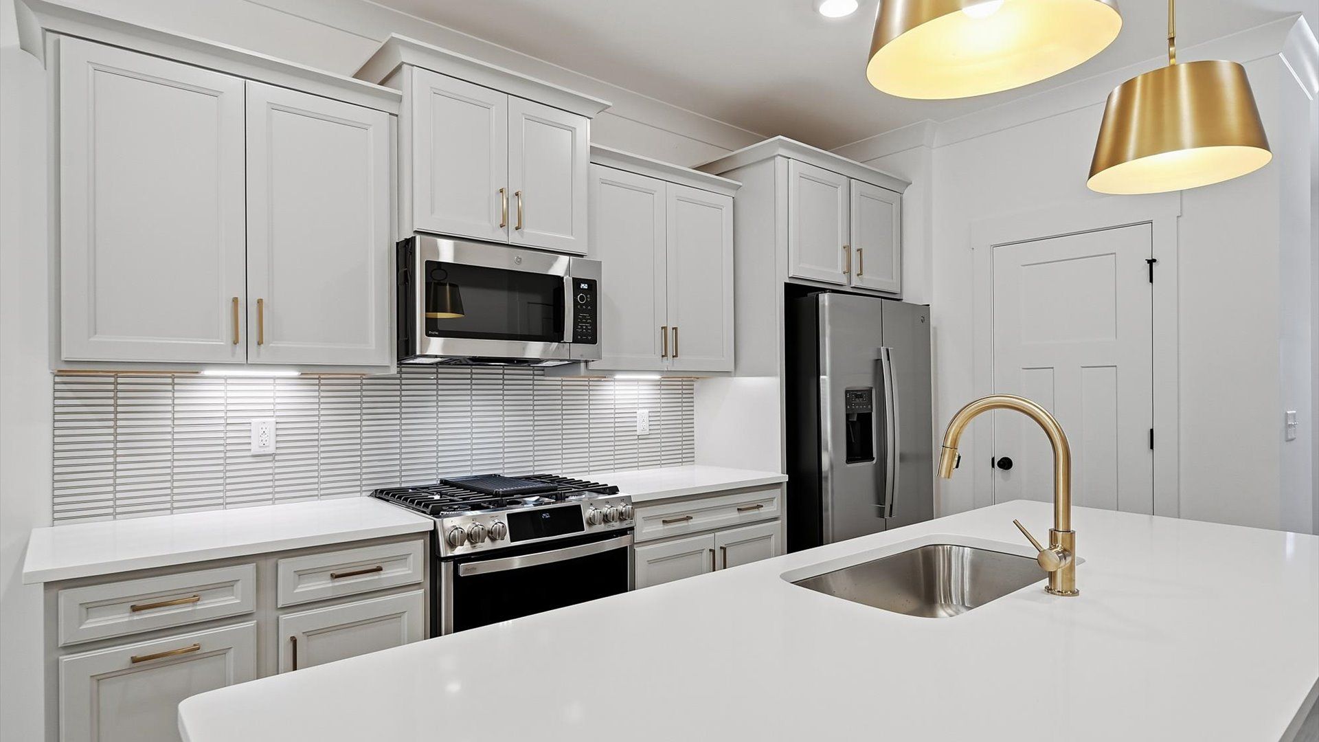 Vibrant kitchen layout with a center island, refined finishes, and open-concept flow