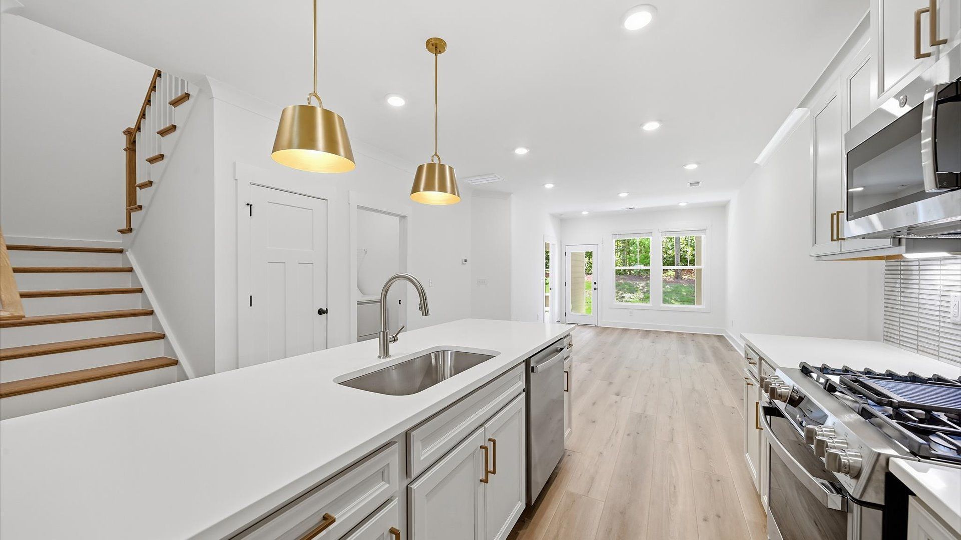 Highly skilled design choices create a clean, open kitchen with a central island