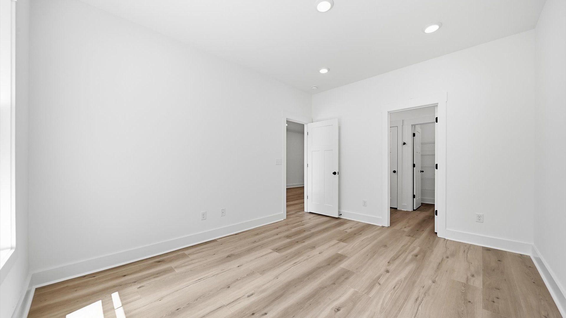 First-class hardwood floors and tasteful finishes elevate the private retreat of this exceptional main-level primary suite