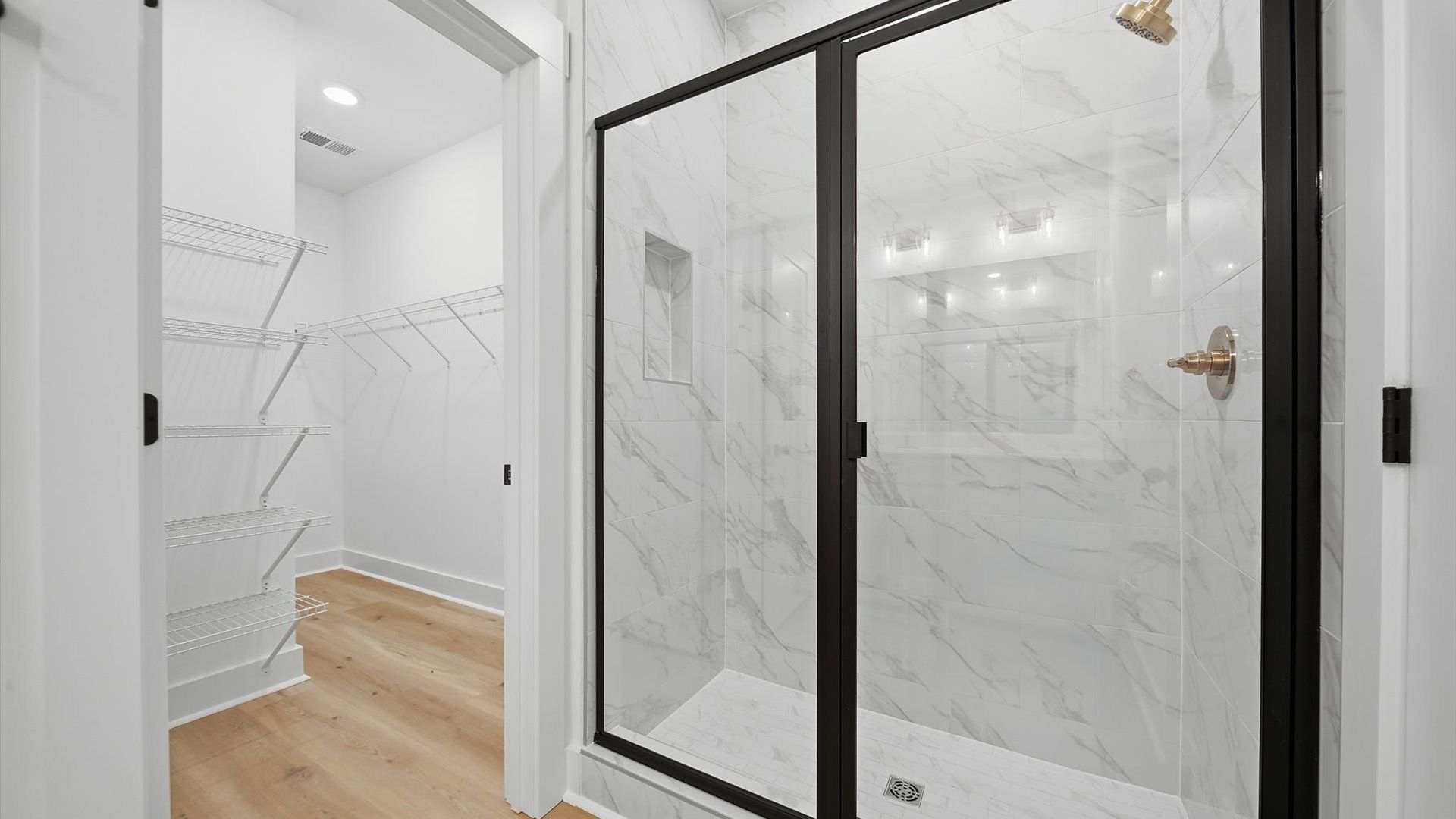 Exceptional en-suite with dual vanity and glass-enclosed tiled walk-in shower for superior everyday comfort