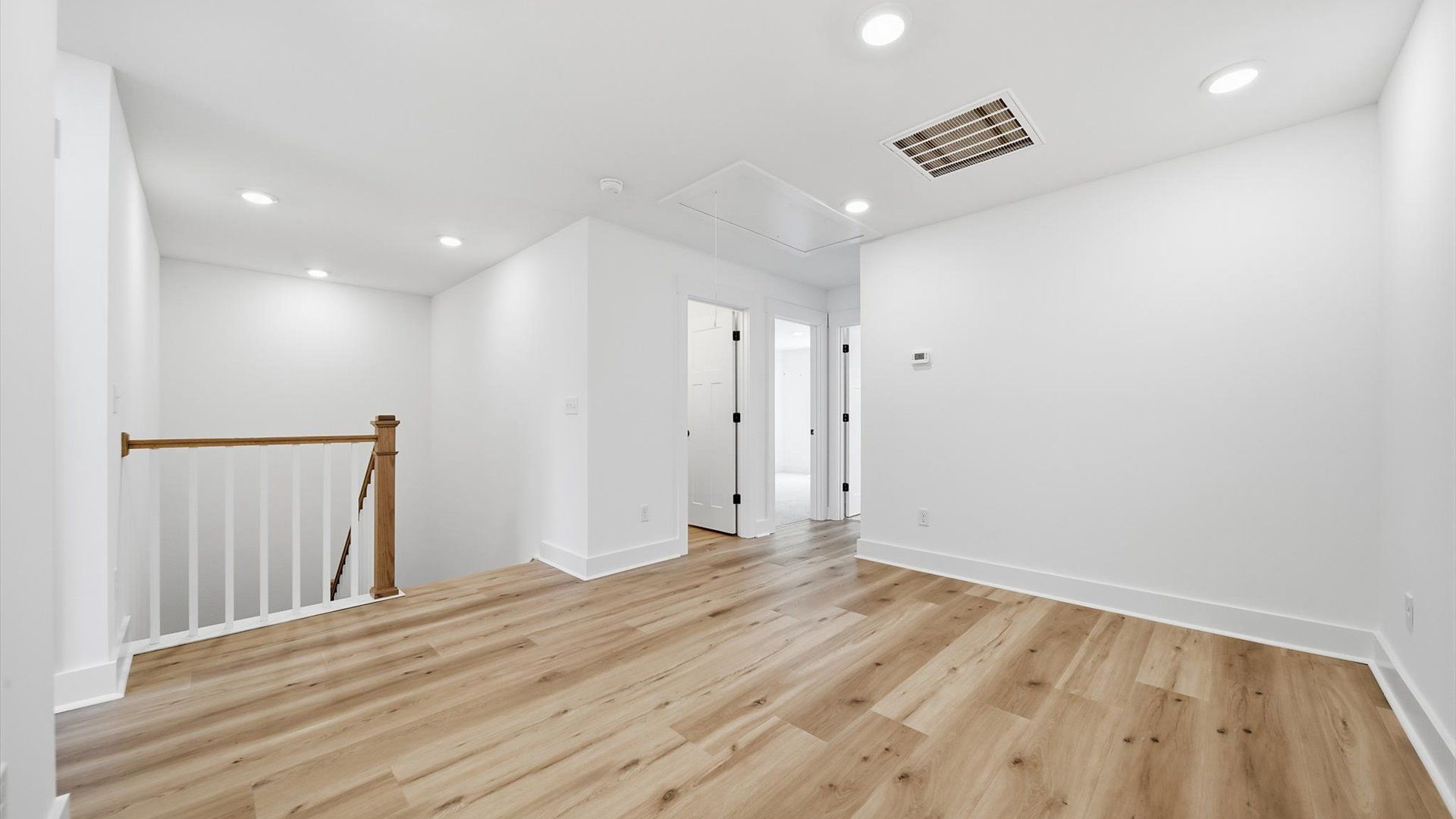 Superior loft with hardwood floors and endless possibilities for a home office, media room, or lounge