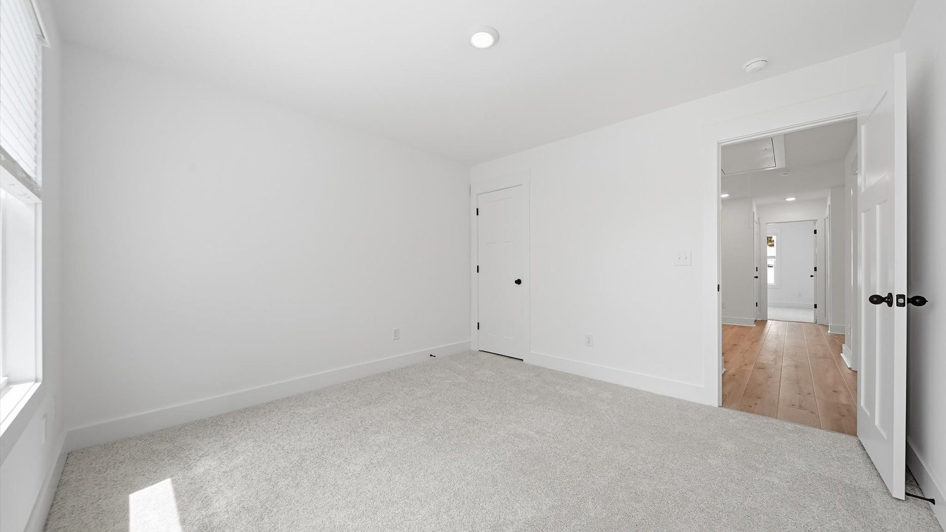 First-rate secondary bedroom with a spacious walk-in closet and elegant carpeted flooring