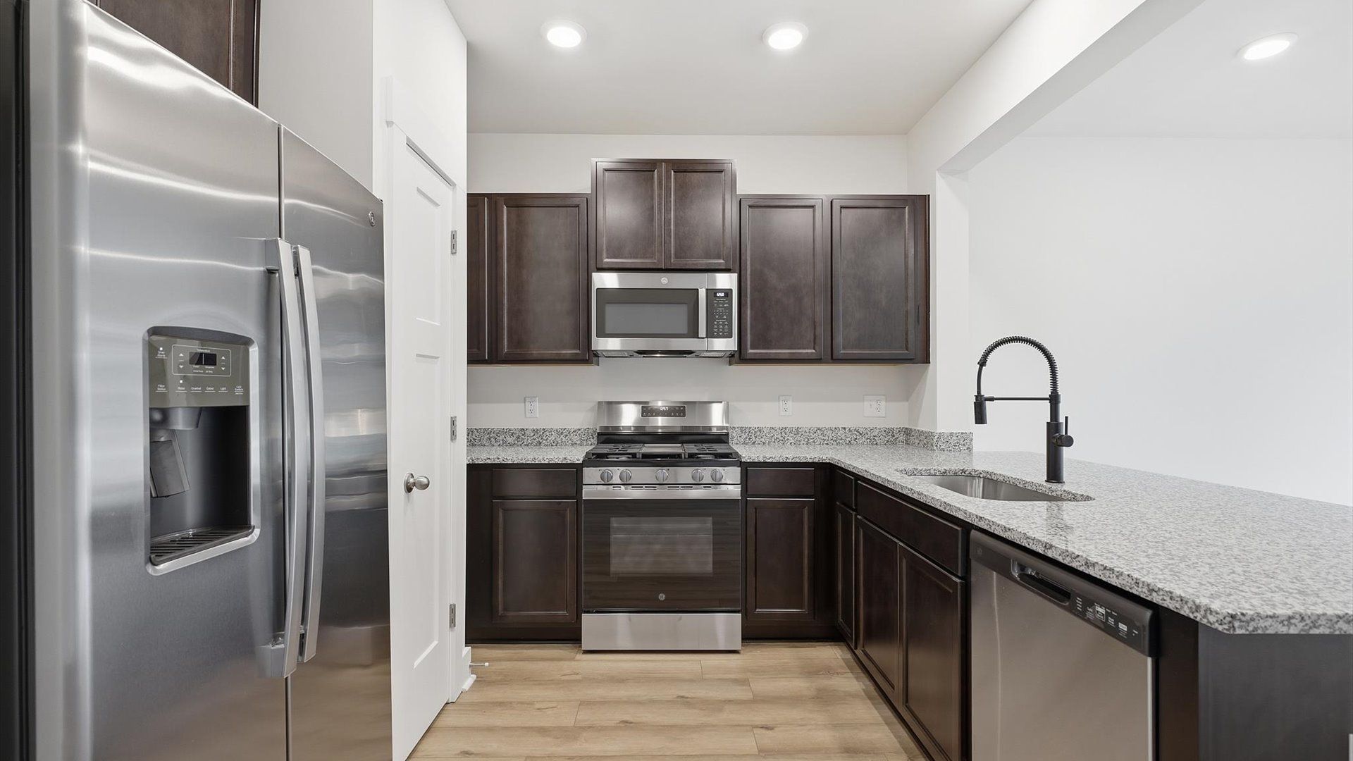 Highly functional kitchen featuring abundant cabinetry and a clean, contemporary design