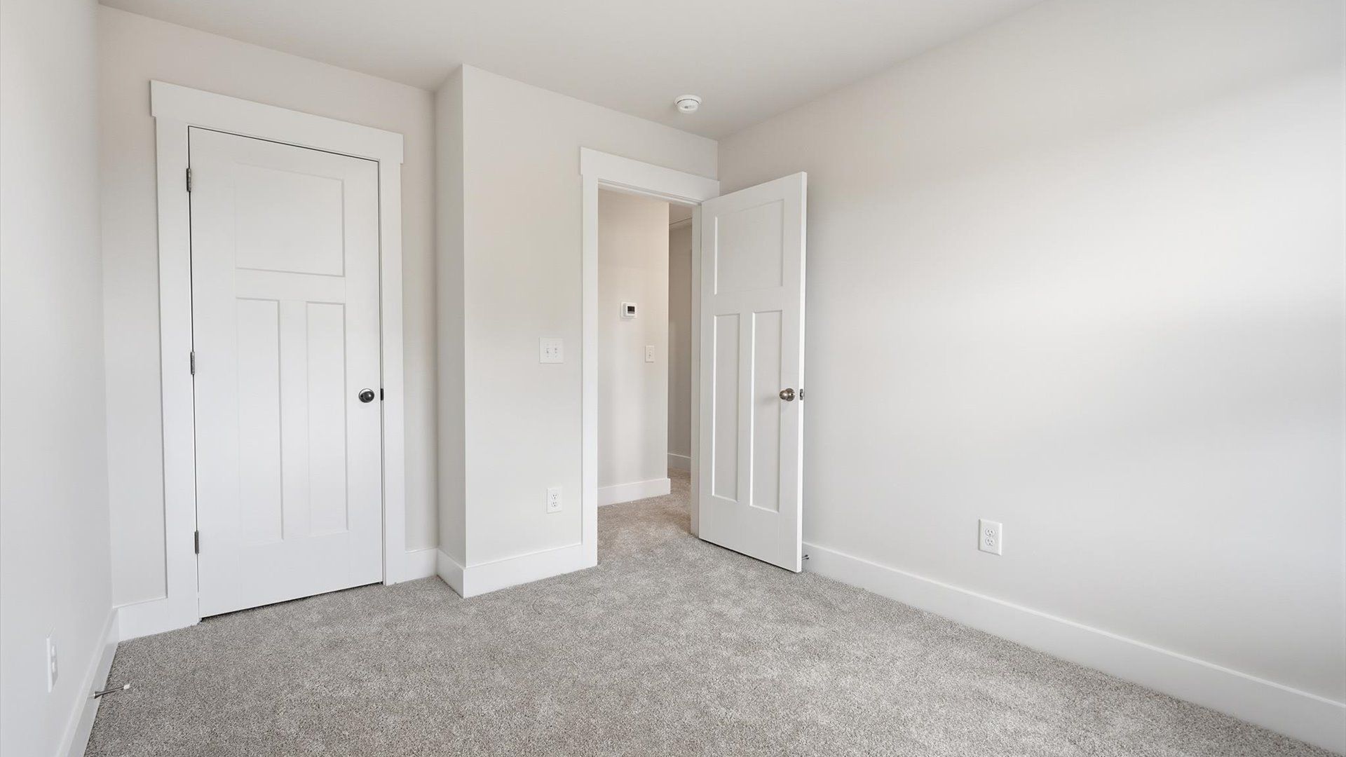 Superior comfort in a secondary bedroom with plush carpet and an oversized walk-in closet