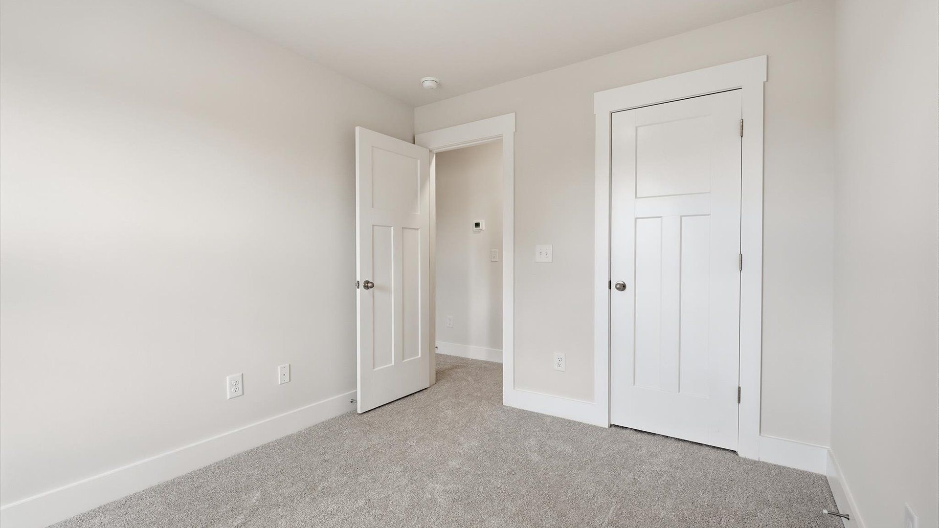 First-class bedroom with generous proportions, a walk-in closet, and beautiful natural light through large windows