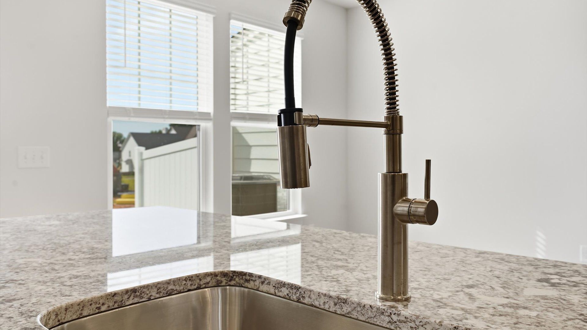 Superior kitchen with granite countertops, polished hardware, and a generously sized island near Downtown Simpsonville