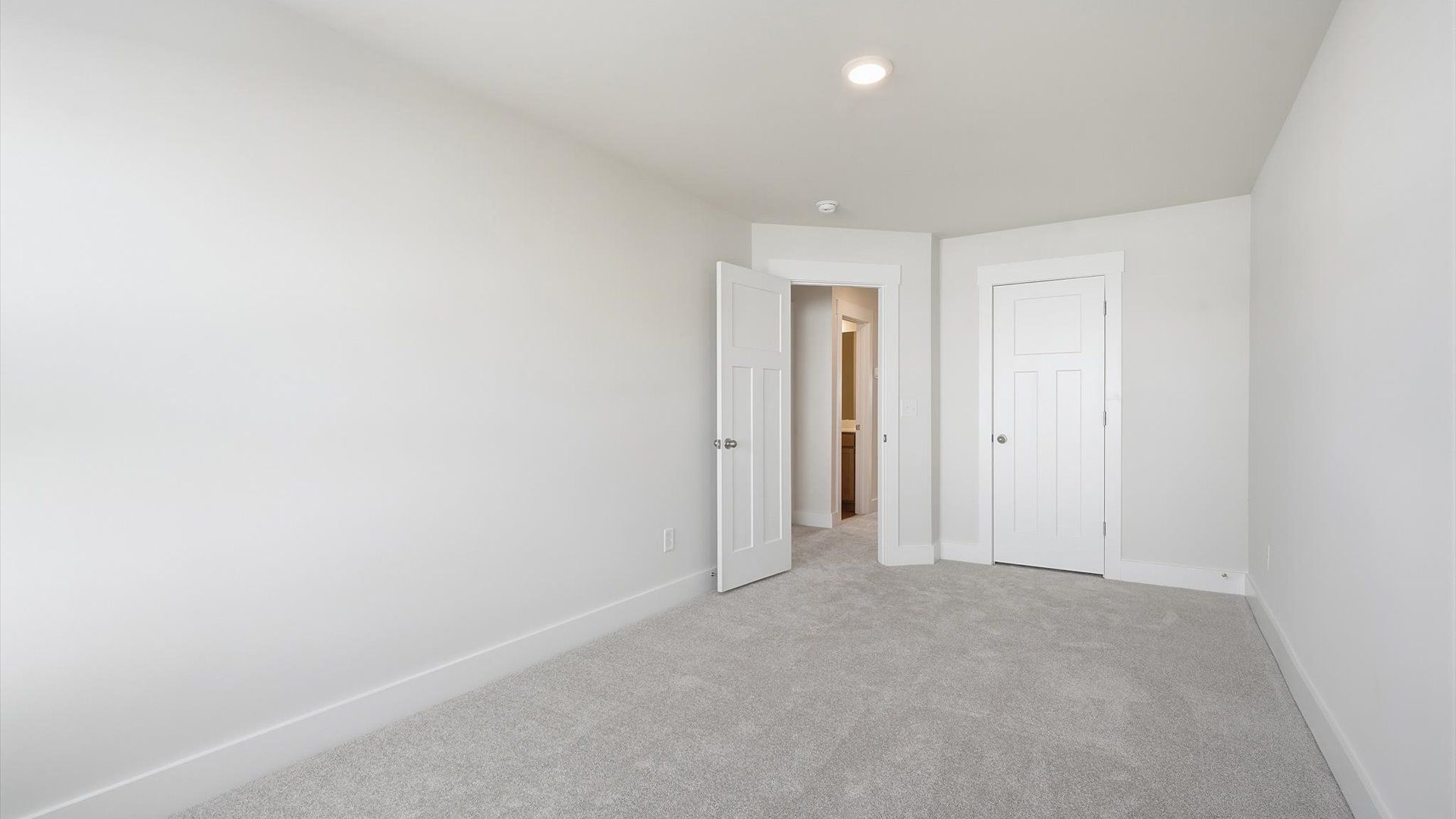 Elegant bedroom retreat featuring soft carpeting and a thoughtfully designed walk-in closet at Gresham Station