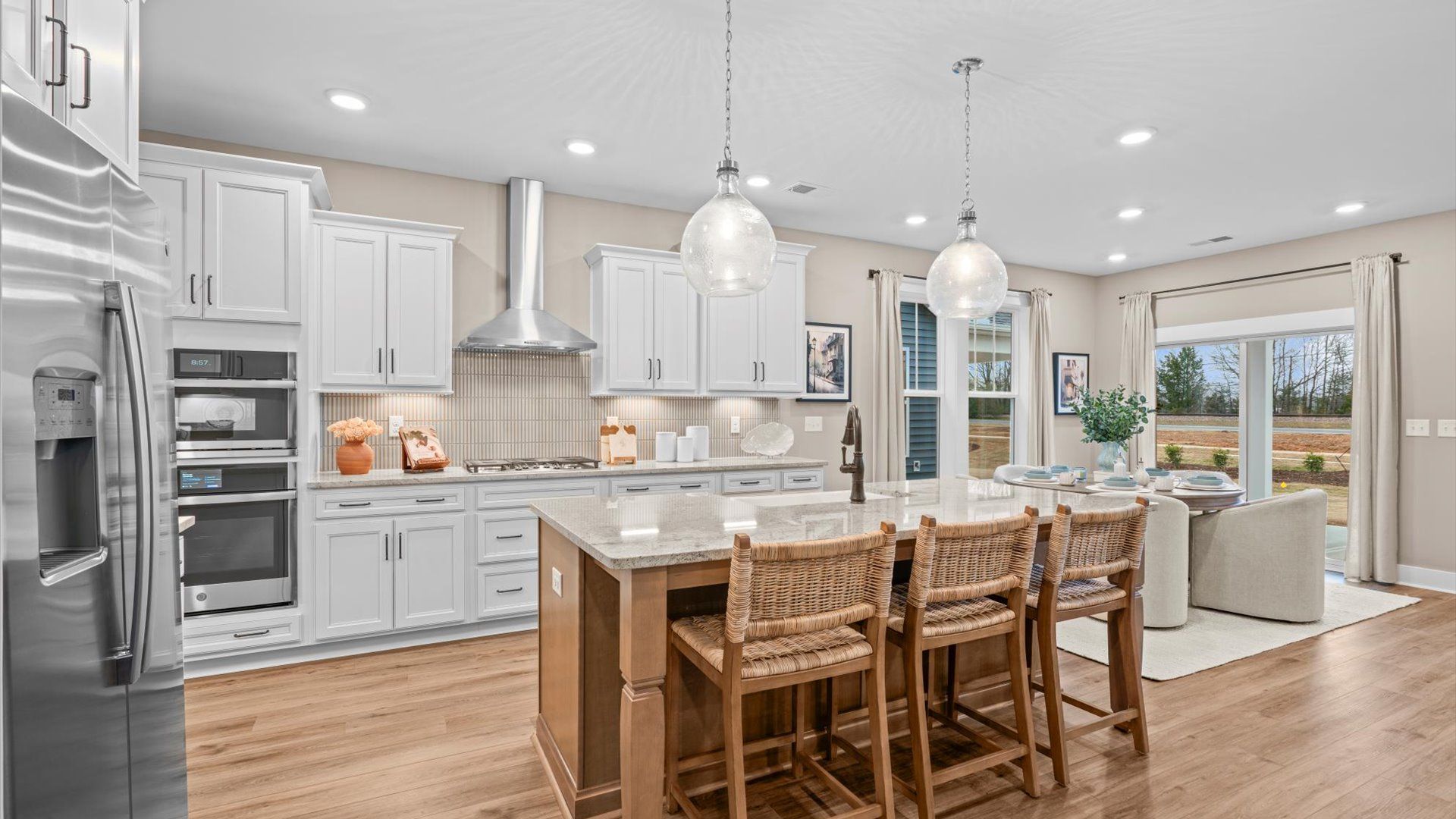 Elegant kitchen with large island and pendant lighting in this first-class DRB Homes design