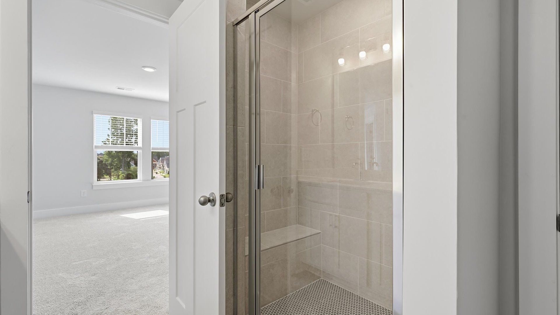 Memorable mornings begin in this elegant primary bathroom with walk-in shower and good lighting located in Simpsonville, SC