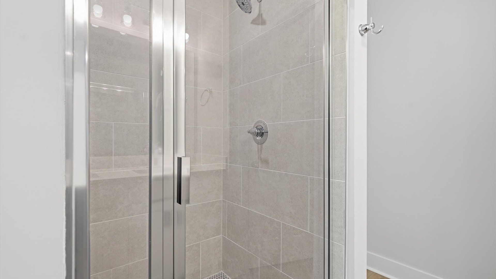 Tasteful primary bath with modern finishes and a walk-in shower located at the Gresham Station community