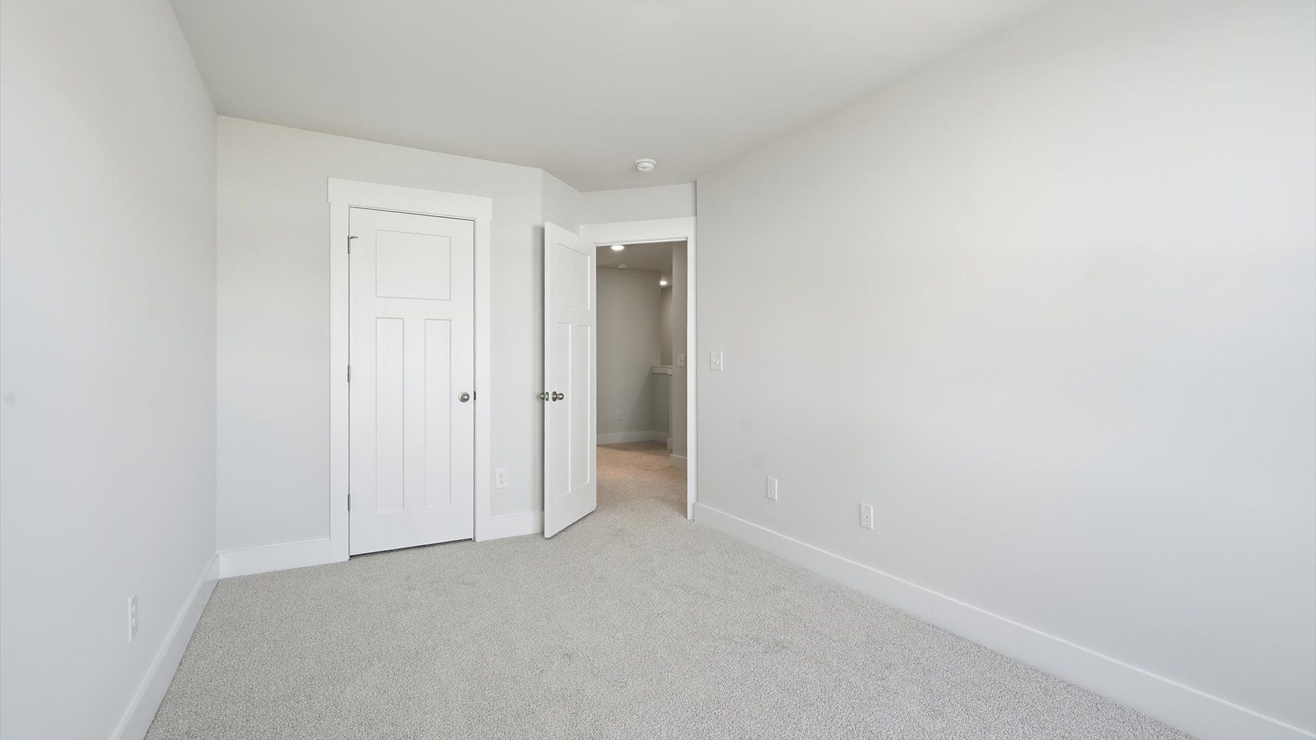 Superior comfort in a secondary bedroom with plush carpet and an oversized walk-in closet by DRB Homes