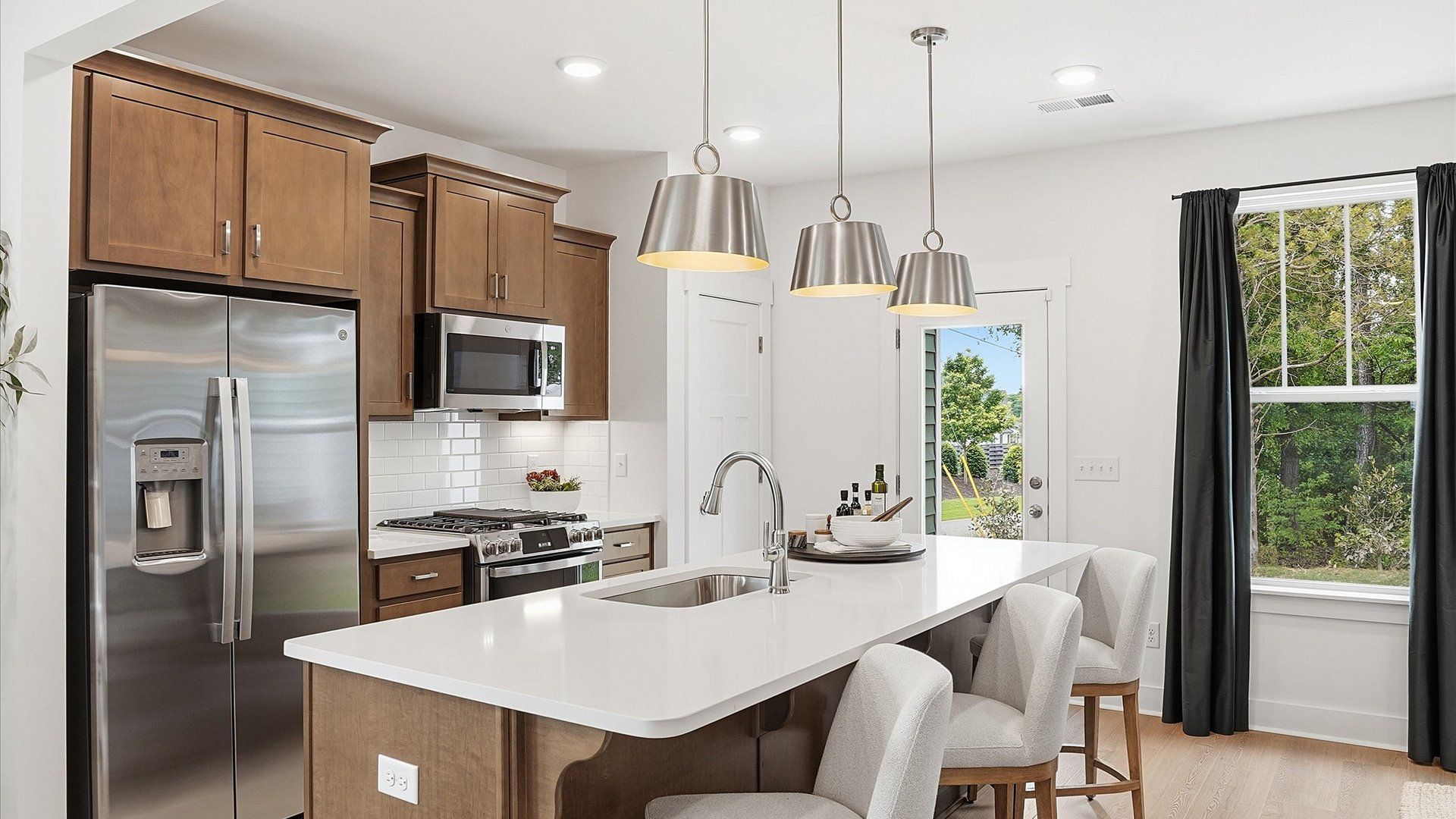Superior craftsmanship shines in this modern kitchen with a space-saving island and open flow at Gresham Station