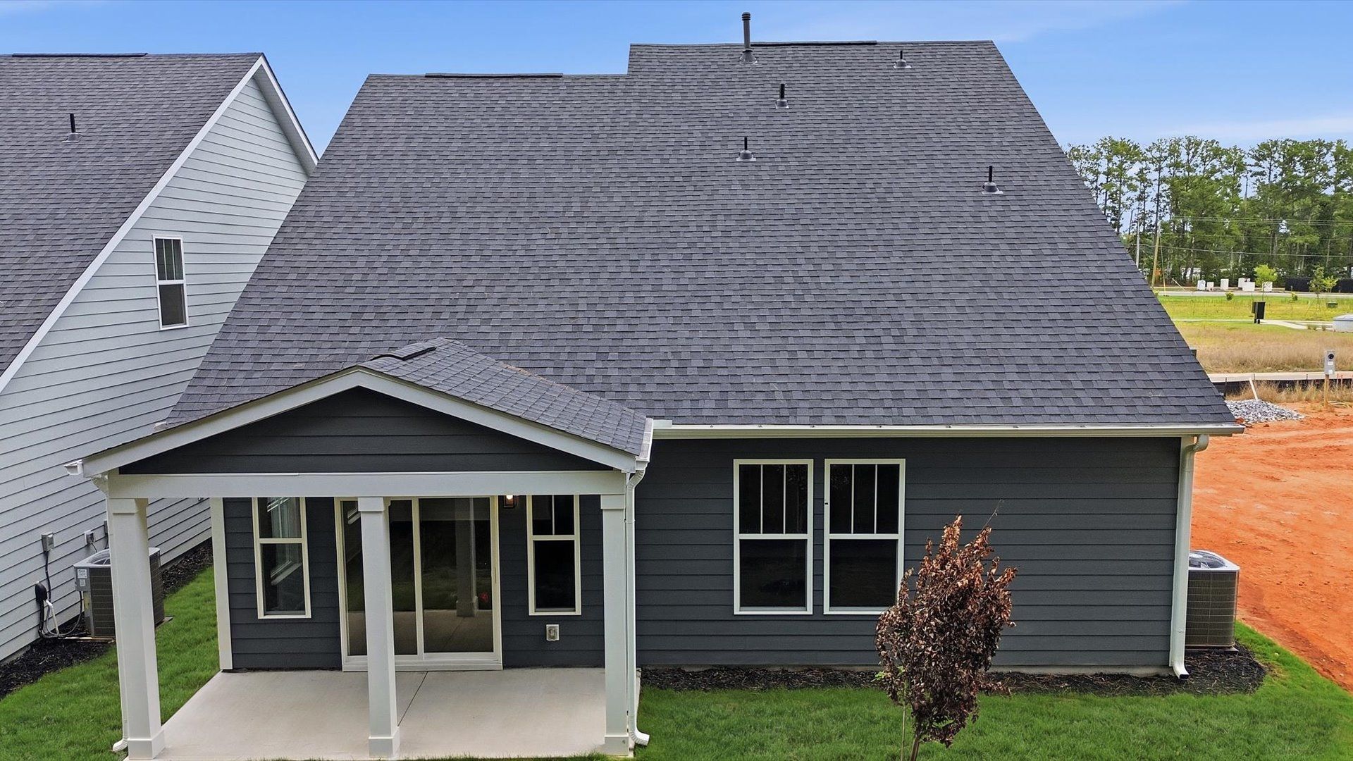 Superior curb appeal continues to the back with a refined, covered outdoor living space located in Fountain Inn, SC