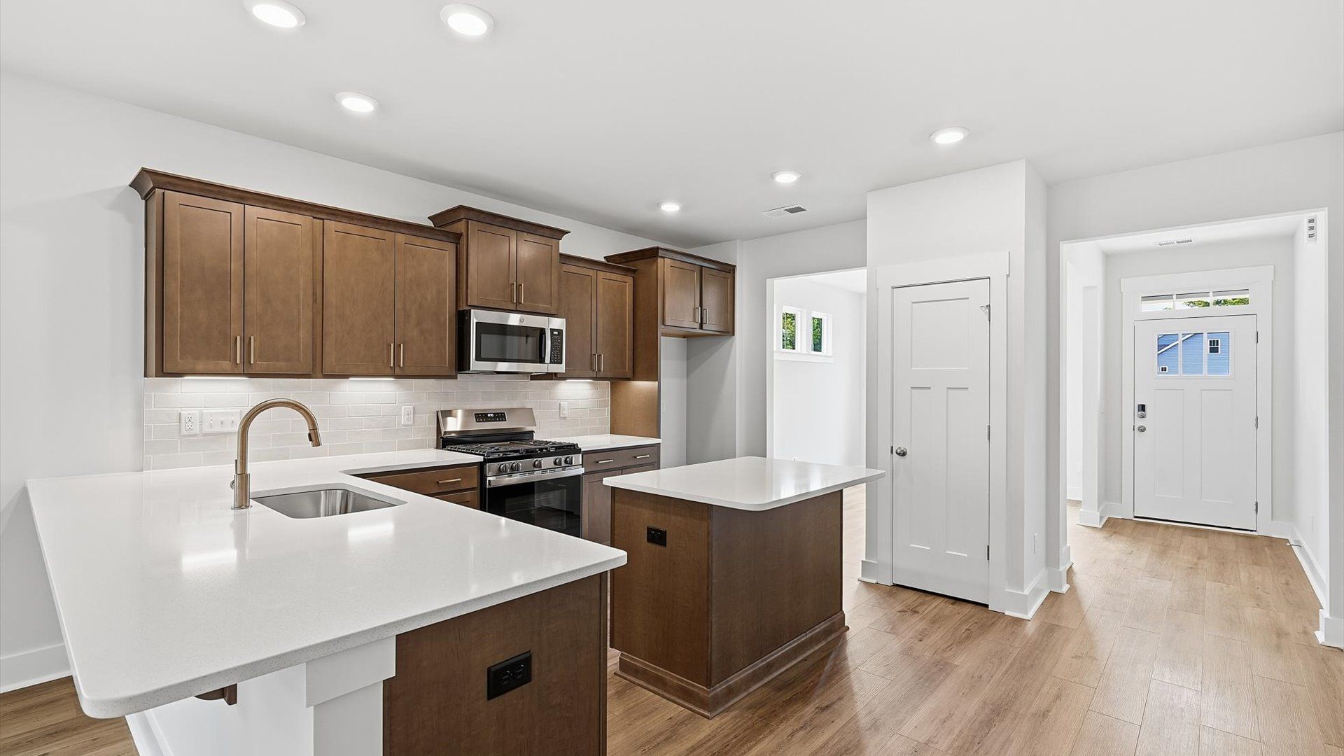 Tasteful kitchen with a streamlined island and modern finishes in a first-class DRB Homes design