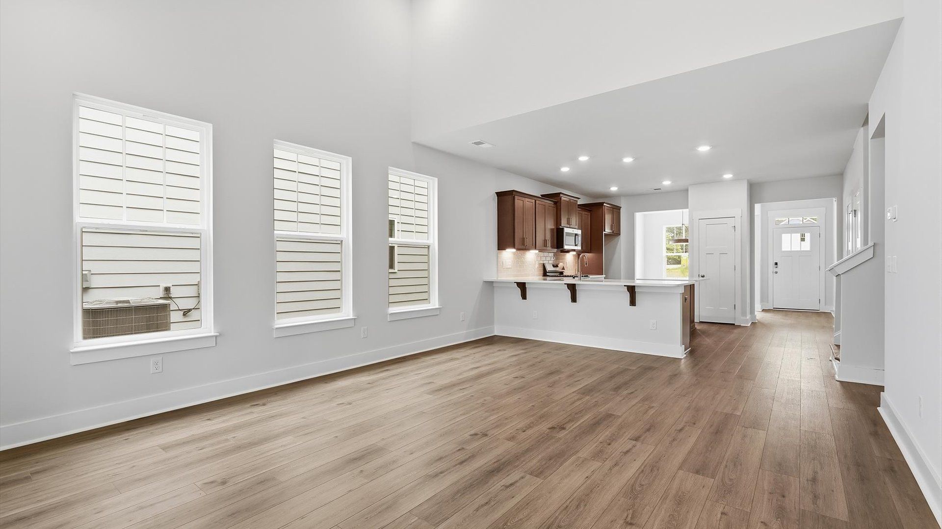 Memorable moments begin in this elegant, open family room with hardwood flooring and refined finishes by DRB Homes