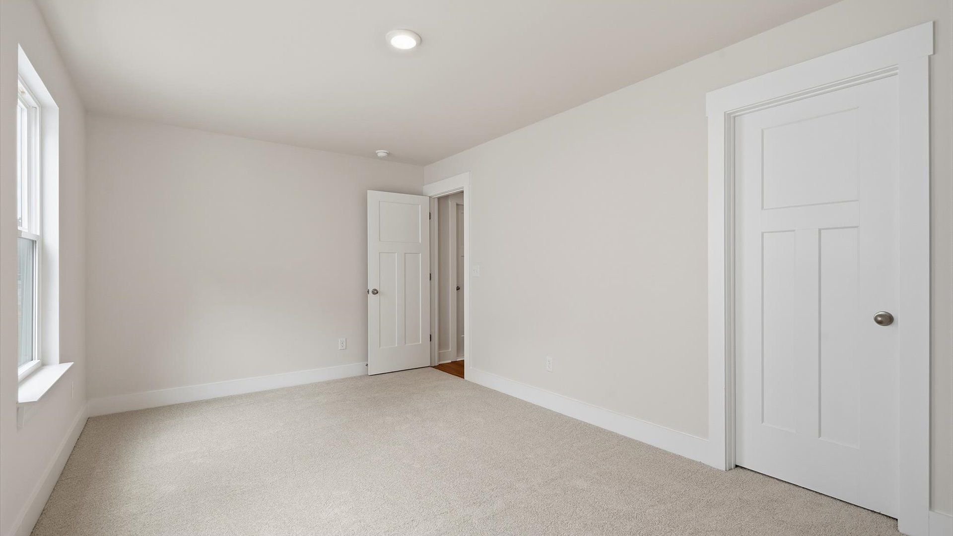 Elegant bedroom retreat featuring soft carpeting and a thoughtfully designed walk-in closet near Downtown Fountain Inn