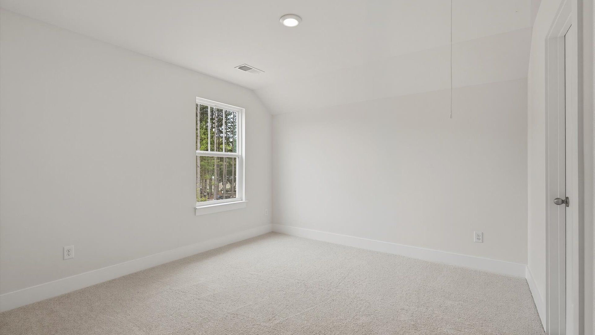 First-rate bedroom with plush carpeting and a large window that provides an open, airy feel