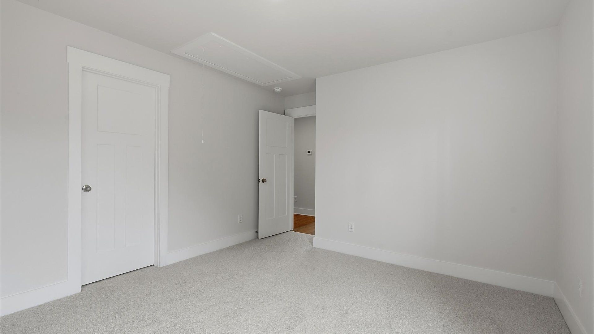 Notable secondary bedroom offering cozy carpeted flooring and a stylish walk-in closet at Barton Hollow