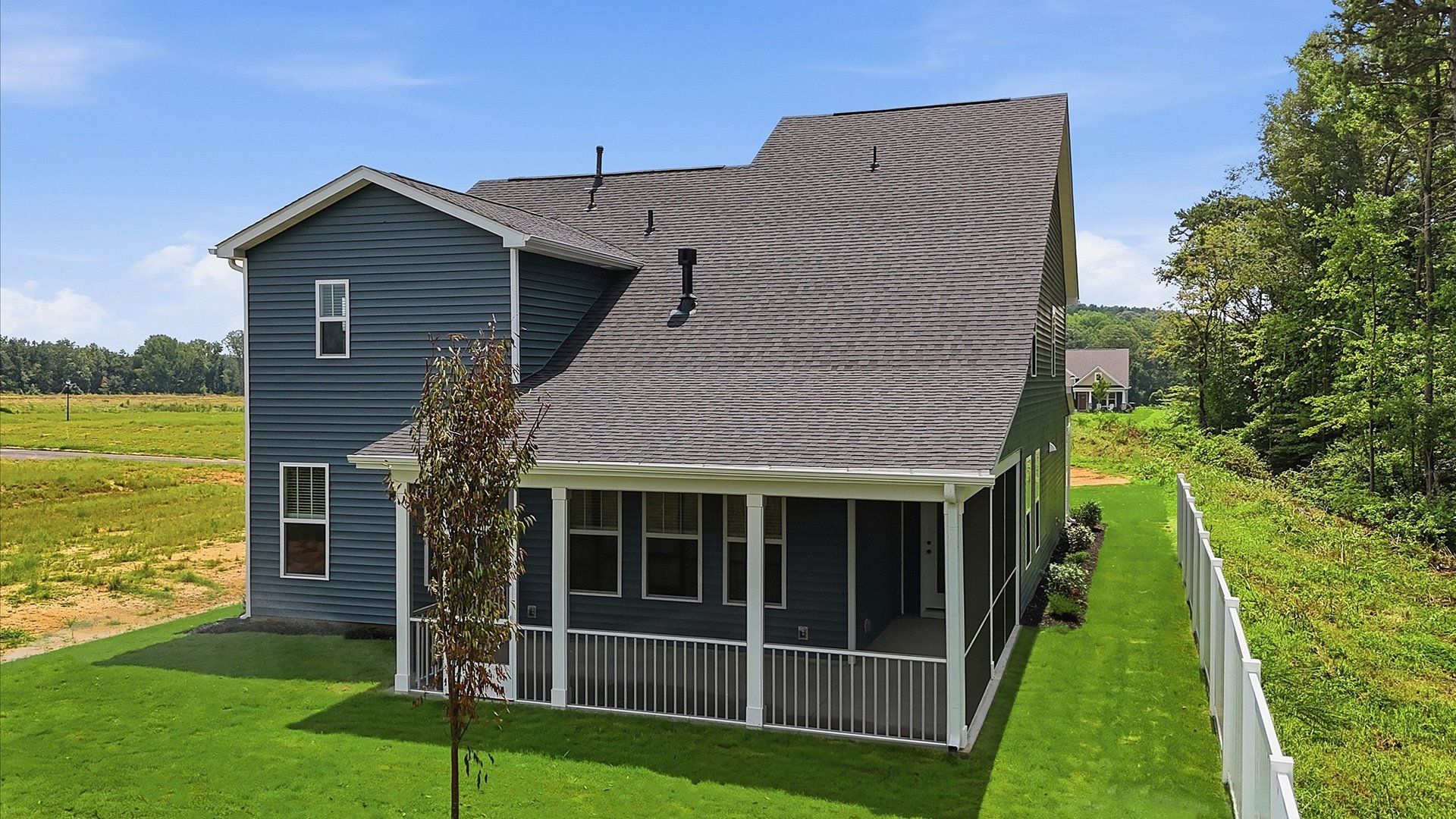 Vibrant rear outdoor space featuring a screened-in porch and exceptional craftsmanship by DRB Homes