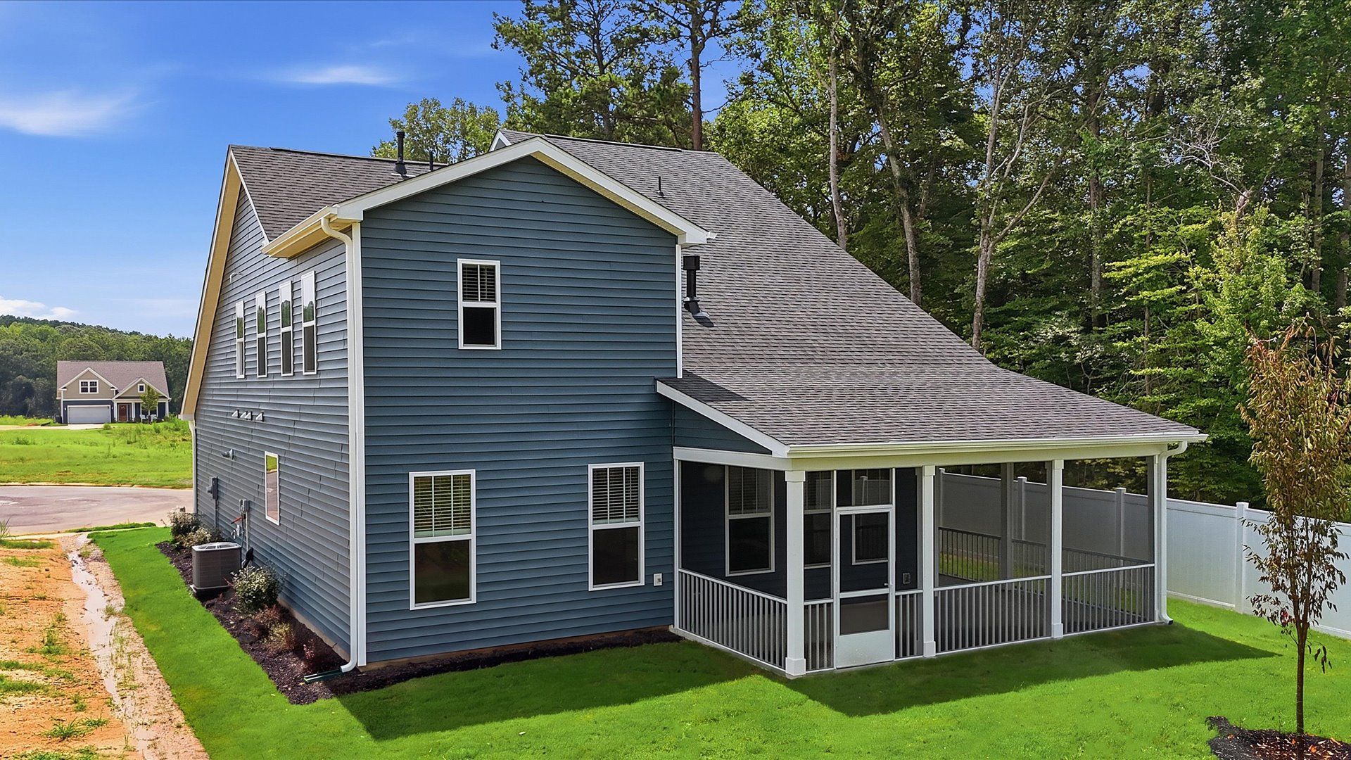 Exceptional outdoor living begins with a screened-in back porch in this thoughtfully designed home at Harrier Point