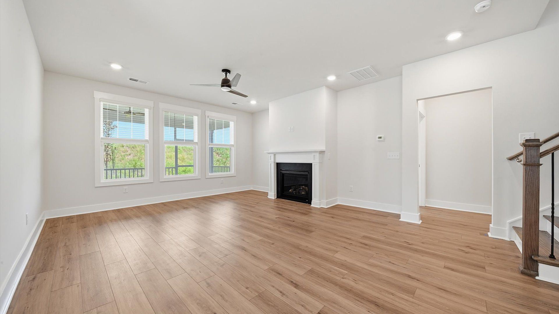 Spacious family room with rich hardwood flooring and elegant trim work in a reputable DRB Homes build