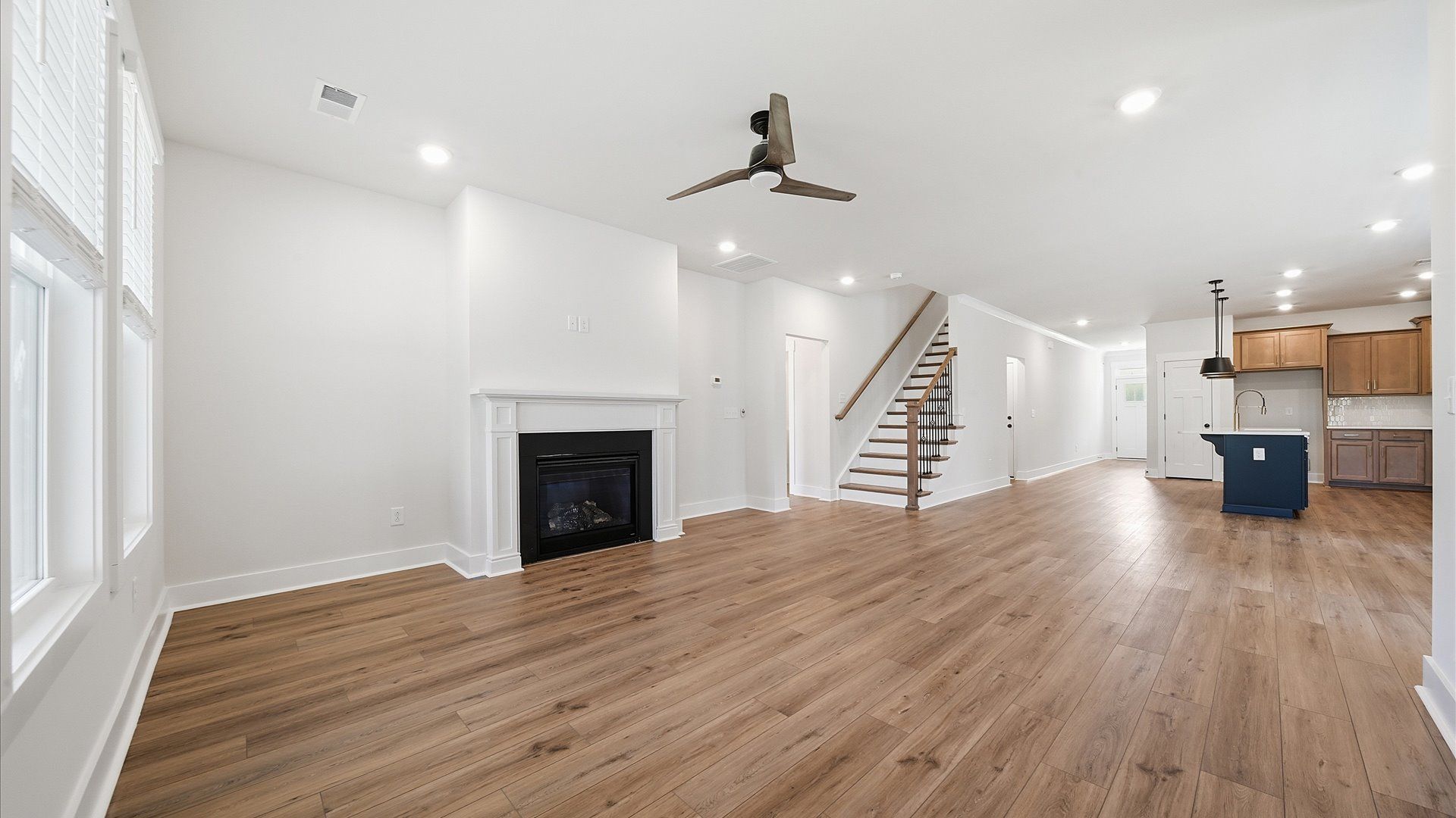 Memorable moments begin in this elegant, open family room with hardwood flooring and refined finishes by DRB Homes