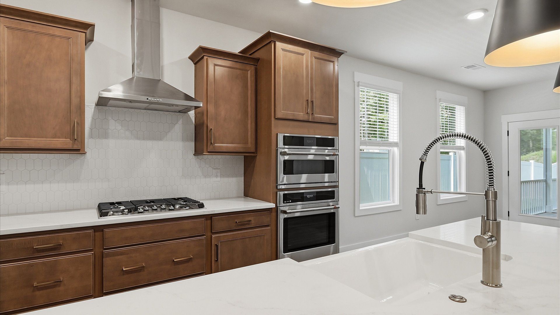 Exclusive kitchen design with large island, pendant lights, and tasteful finishes throughout at Harrier Point