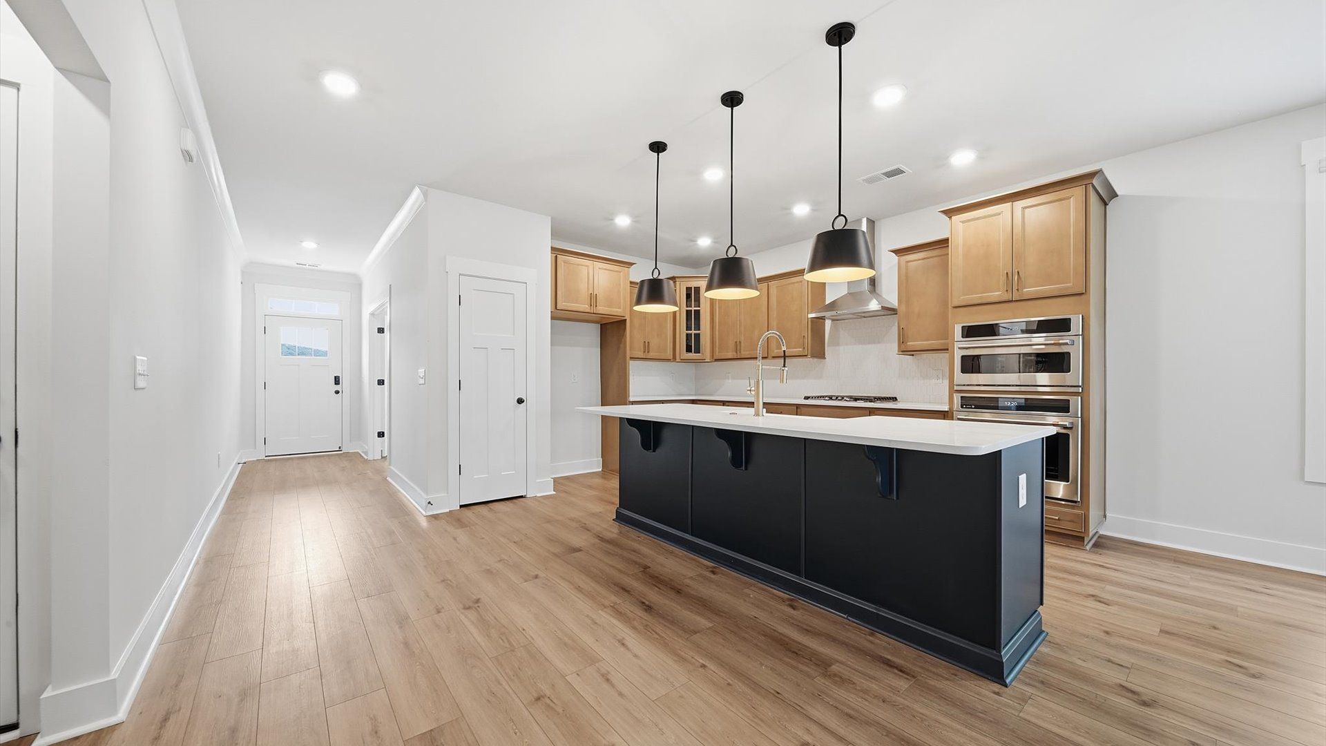 Expansive kitchen offering exceptional workspace and effortless flow to adjacent living areas by DRB Homes