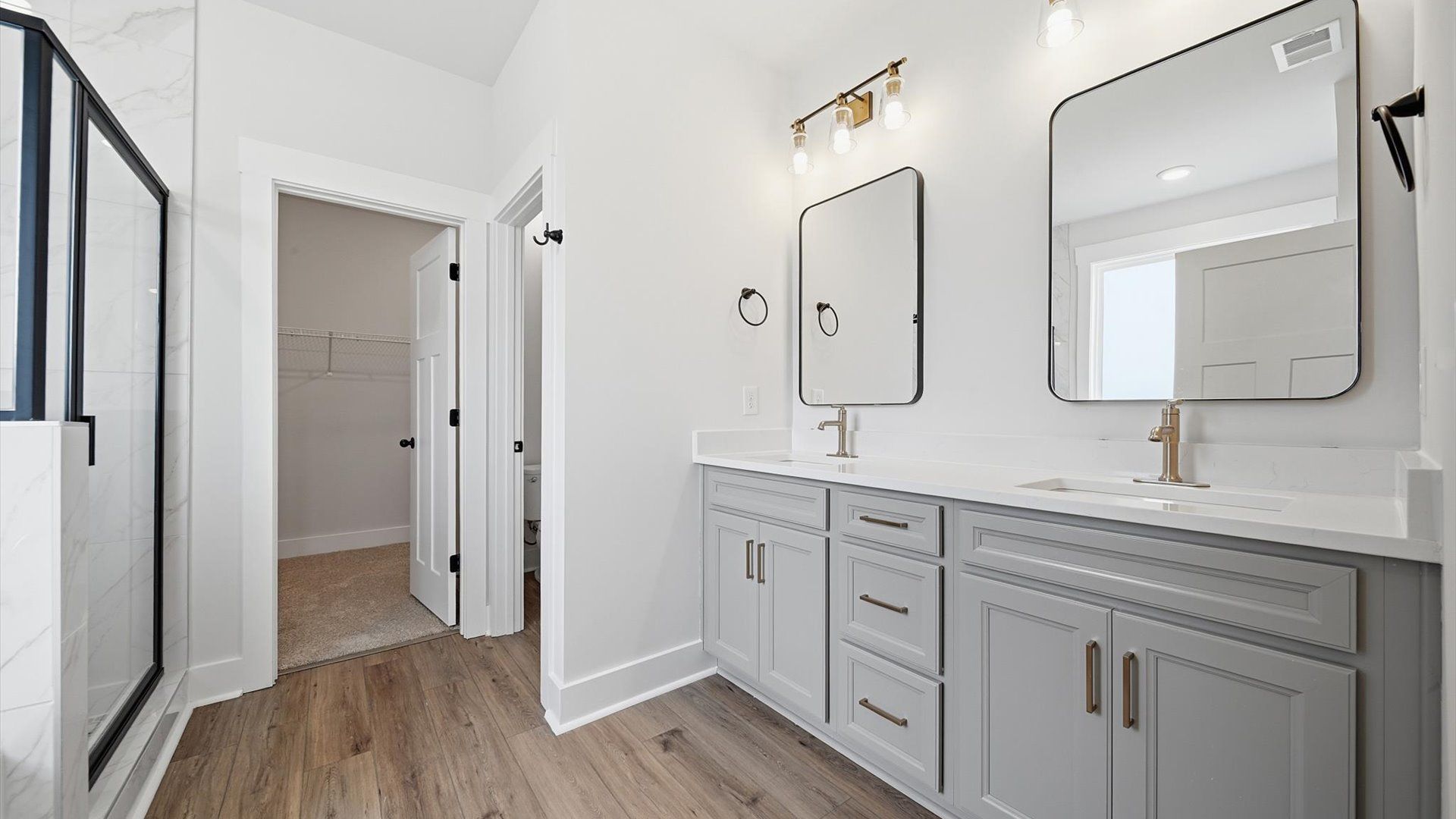 Memorable mornings begin in this elegant primary bathroom with walk-in shower and double vanity in Woodruff, SC
