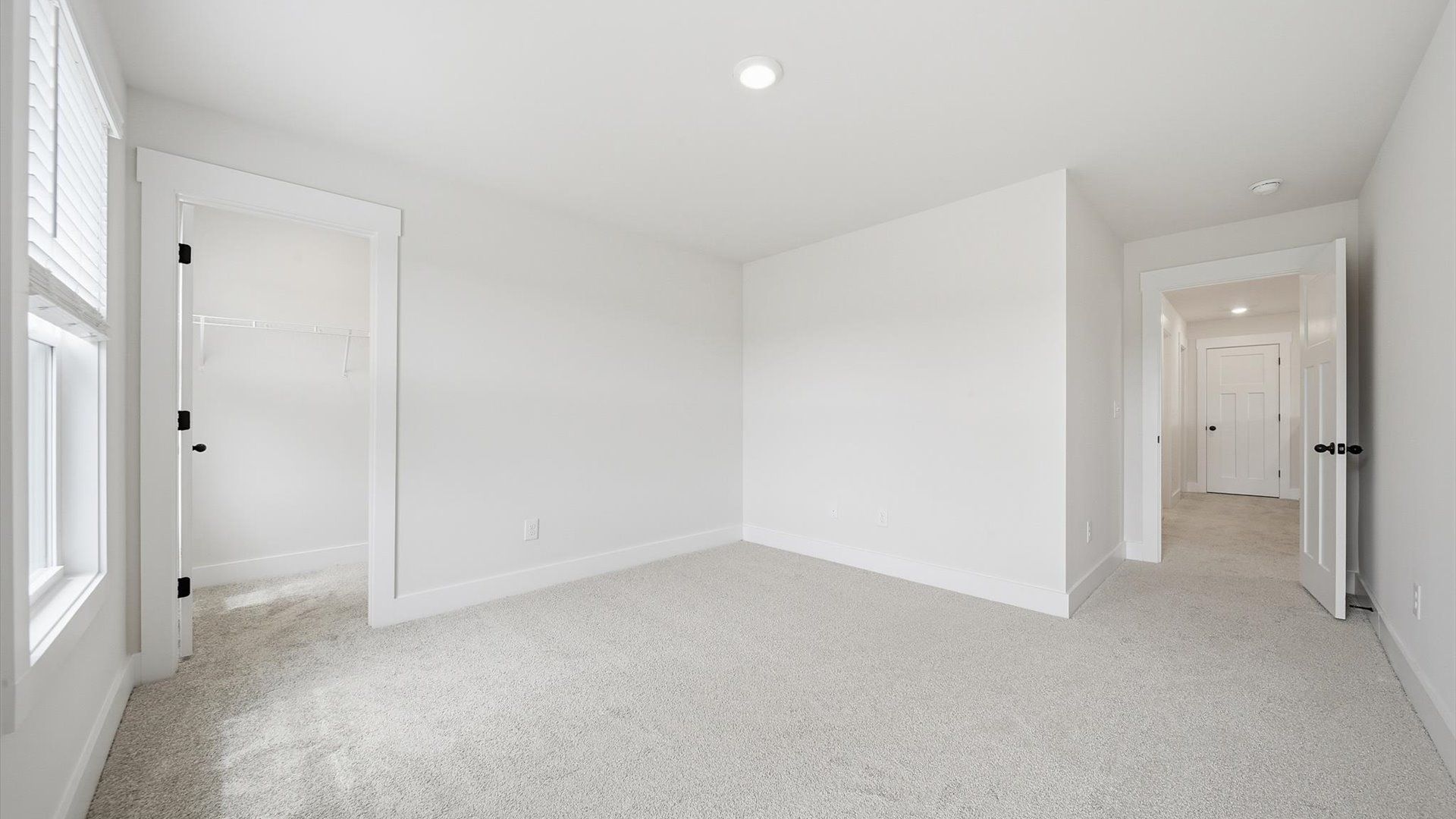 Superior comfort in a secondary bedroom with plush carpet and an oversized walk-in closet at Harrier Point