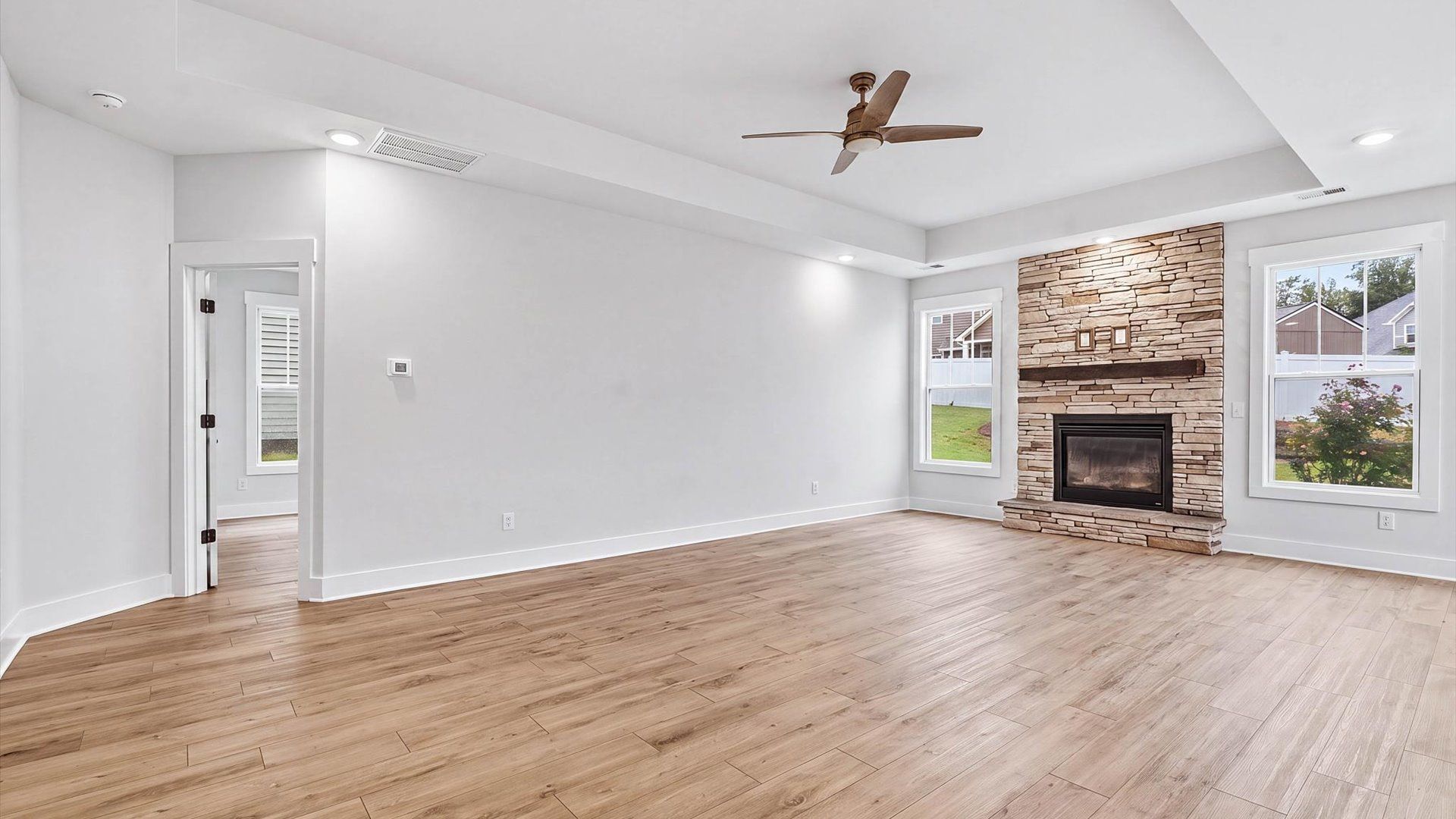 Spacious and stylish family room with a tray ceiling that creates a bright and open atmosphere located in Spartanburg, SC