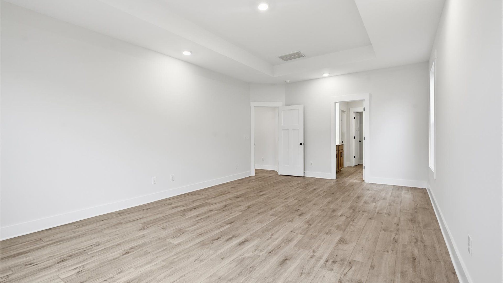 Serene and stylish primary bedroom featuring hardwood flooring and a thoughtful, modern layout in Spartanburg, SC