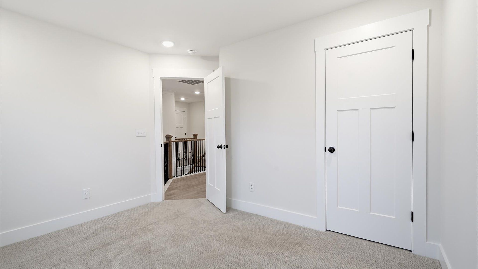 Accomplished design shines in this carpeted bedroom with a functional walk-in closet in Spartanburg, SC