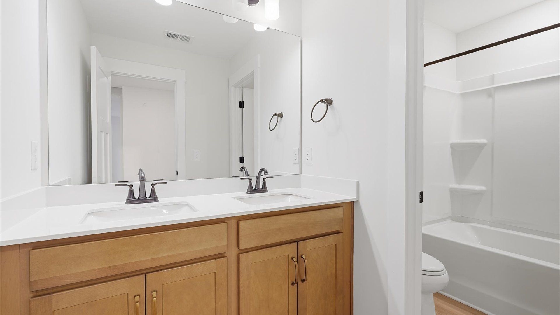 Well-appointed full bath with high standards of craftsmanship and everyday function by DRB Homes