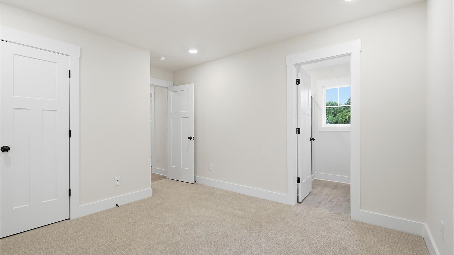 Notable secondary bedroom offering cozy carpeted flooring and a stylish walk-in closet by DRB Homes