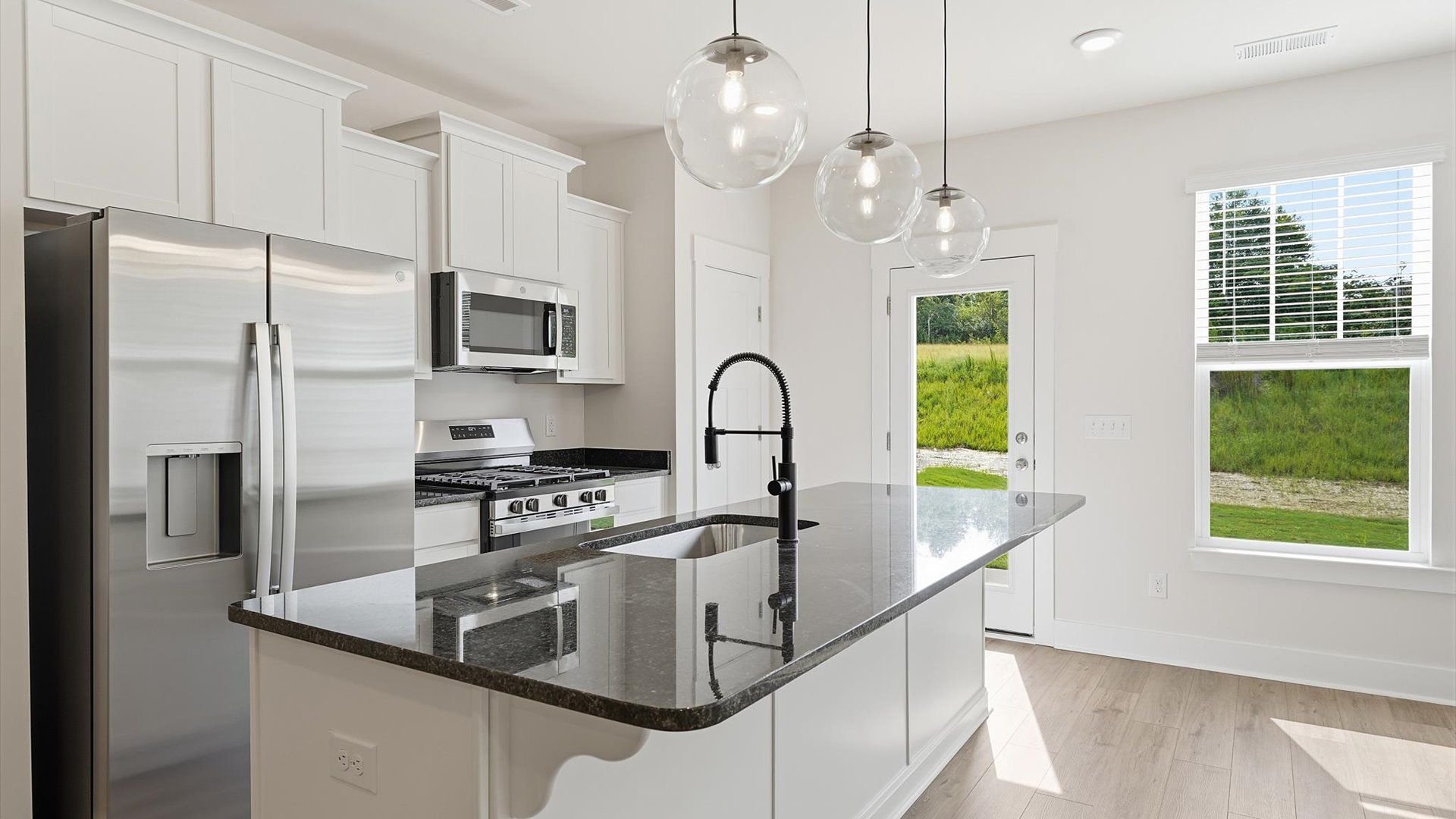 Accomplished design in a kitchen that blends function and form with a right-sized island at Marion Square