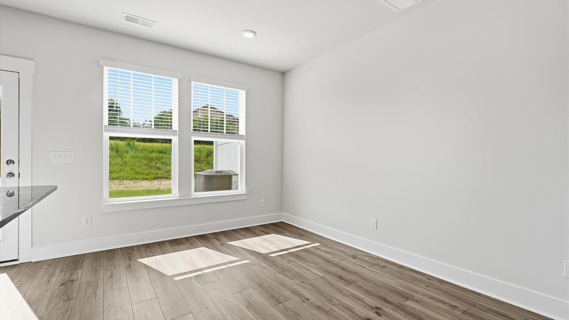 Light-filled breakfast area offering a comfortable space to gather and unwind near Downtown Greenville